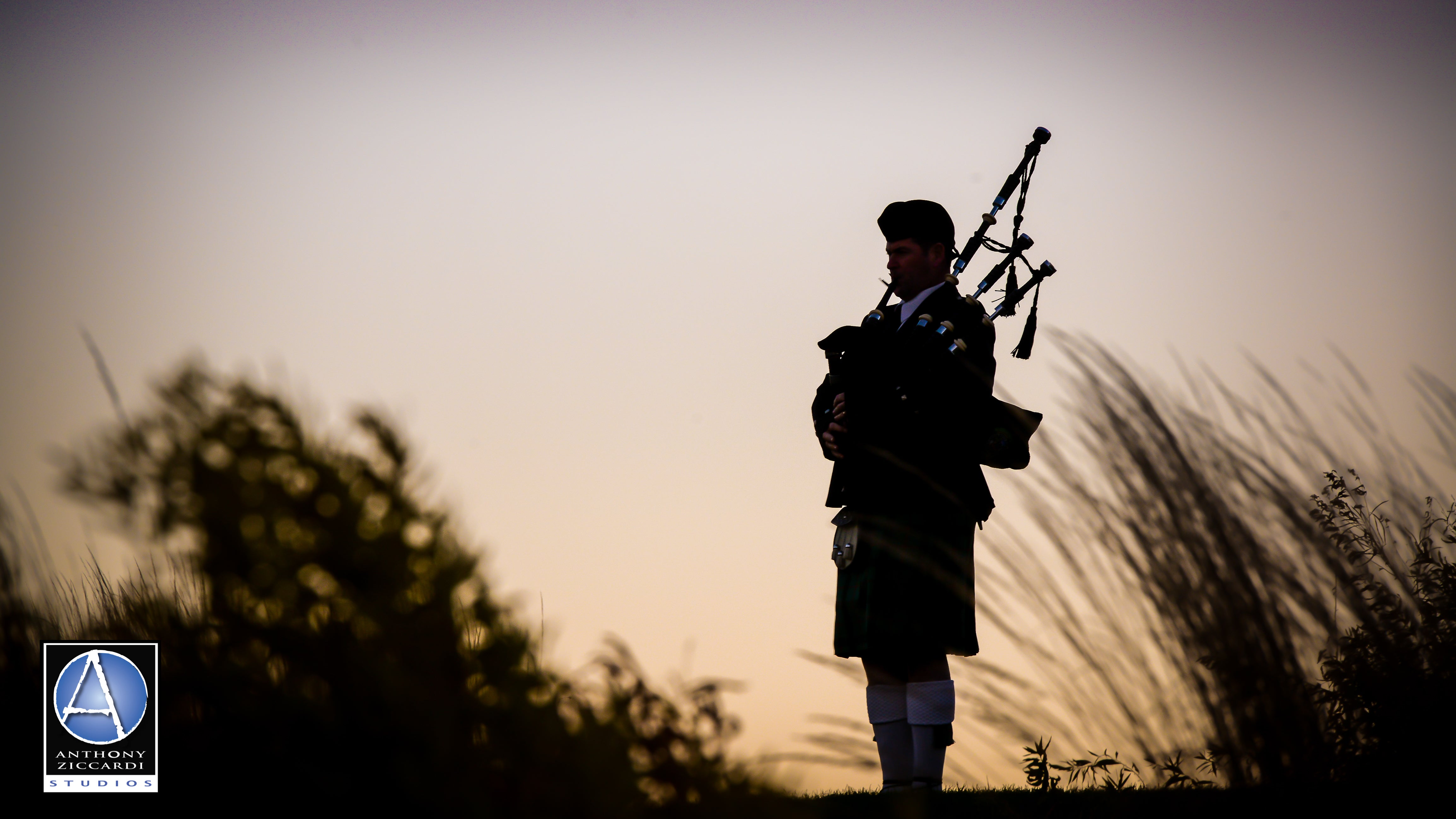 Silhouette of bagpiper playing