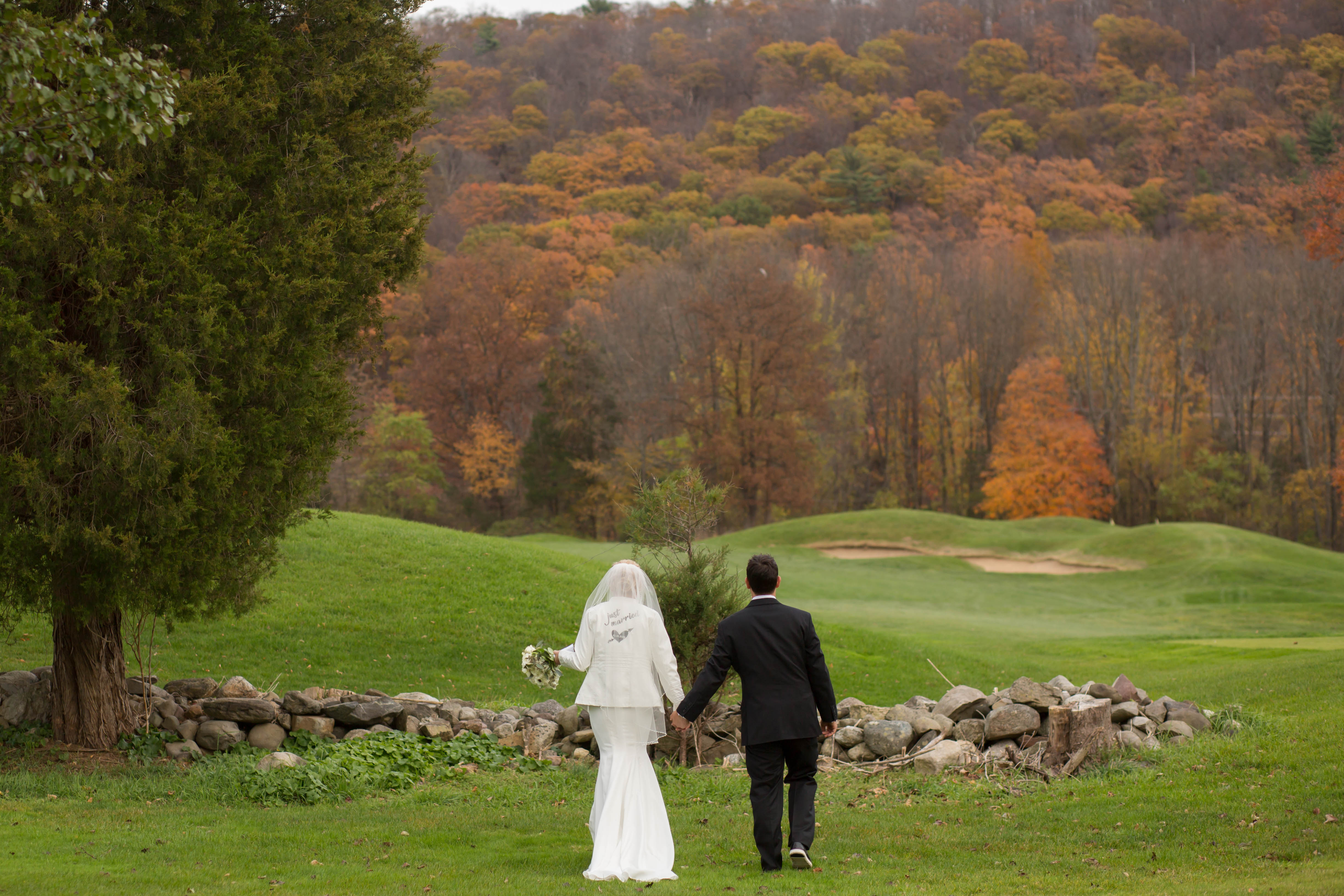 Bride and groom walking the grounds of Black Bear Golf Club