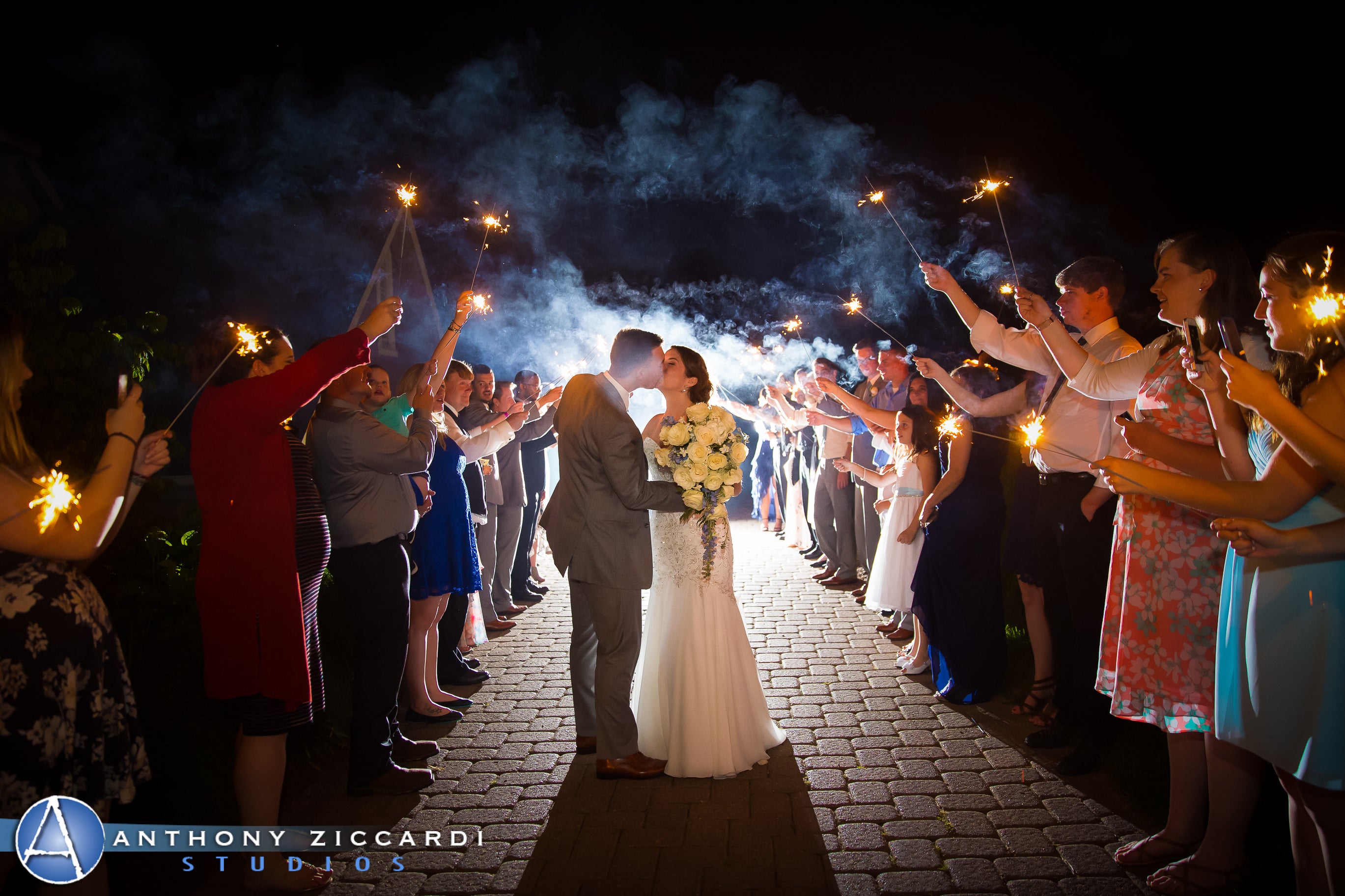 Bride and groom kiss during their sparkler send off.