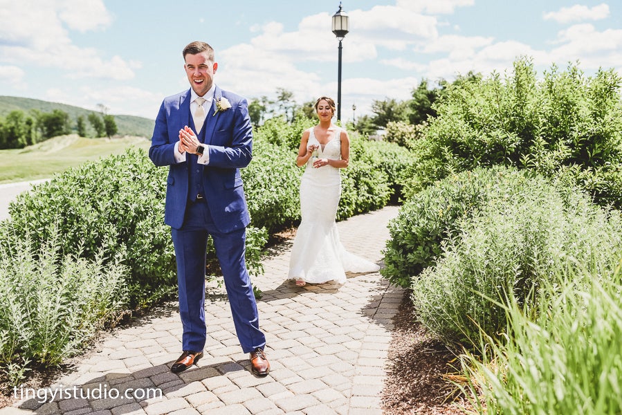 Bride and Groom first look on path in front of Grand Cascades Lodge