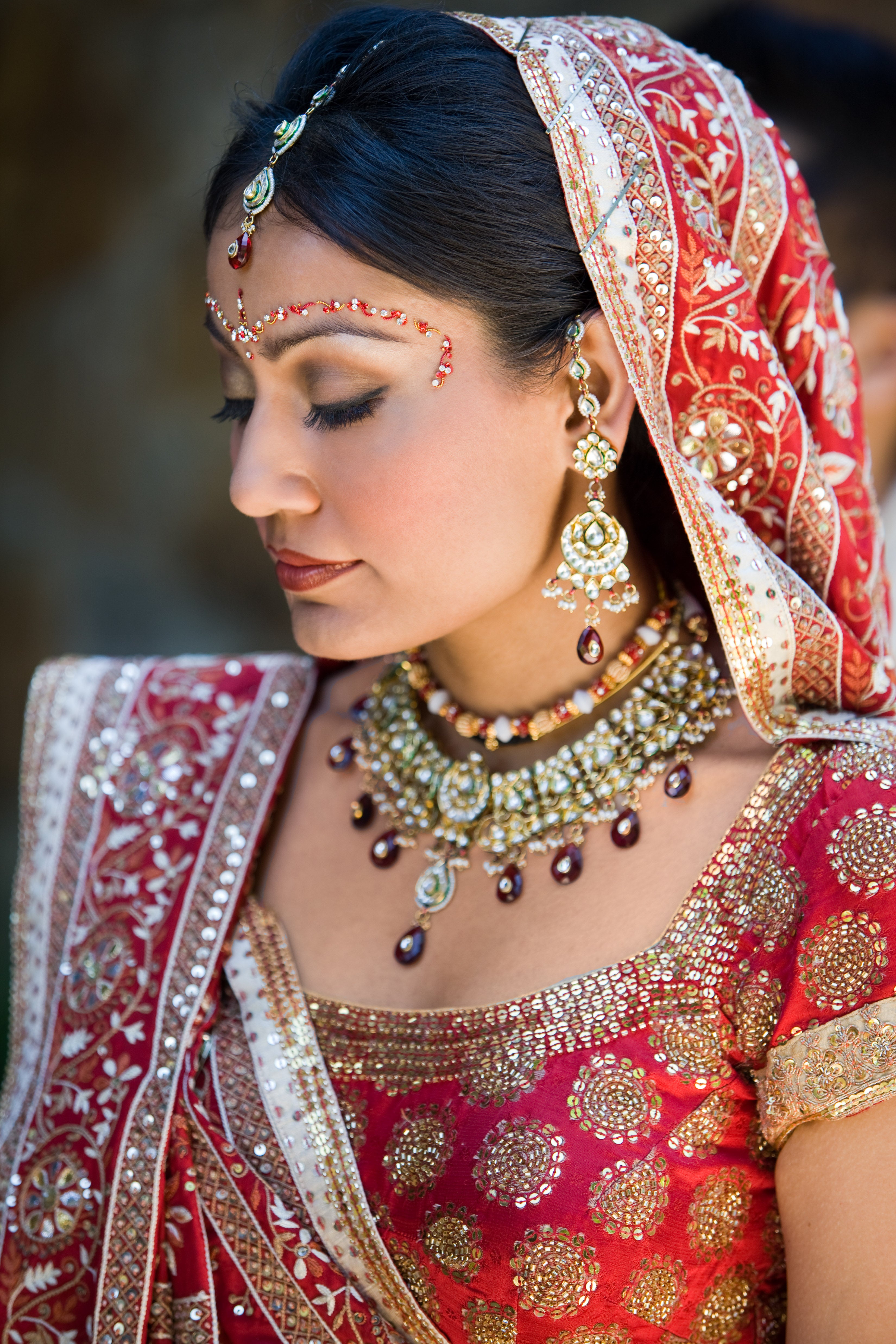 Indian bride dressed in a red and gold saree