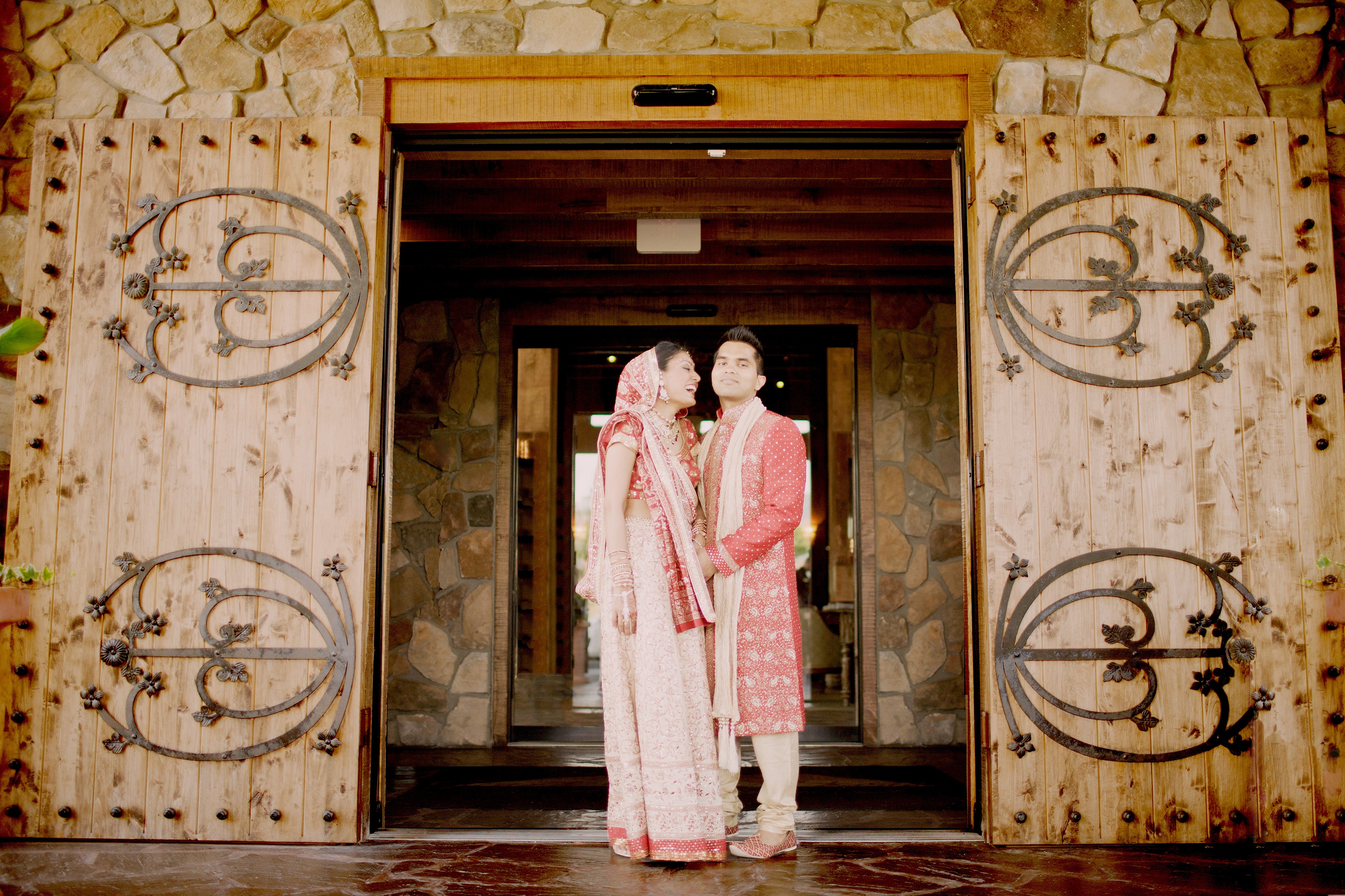 Indian wedding couple in front of Grand Cascades Lodge