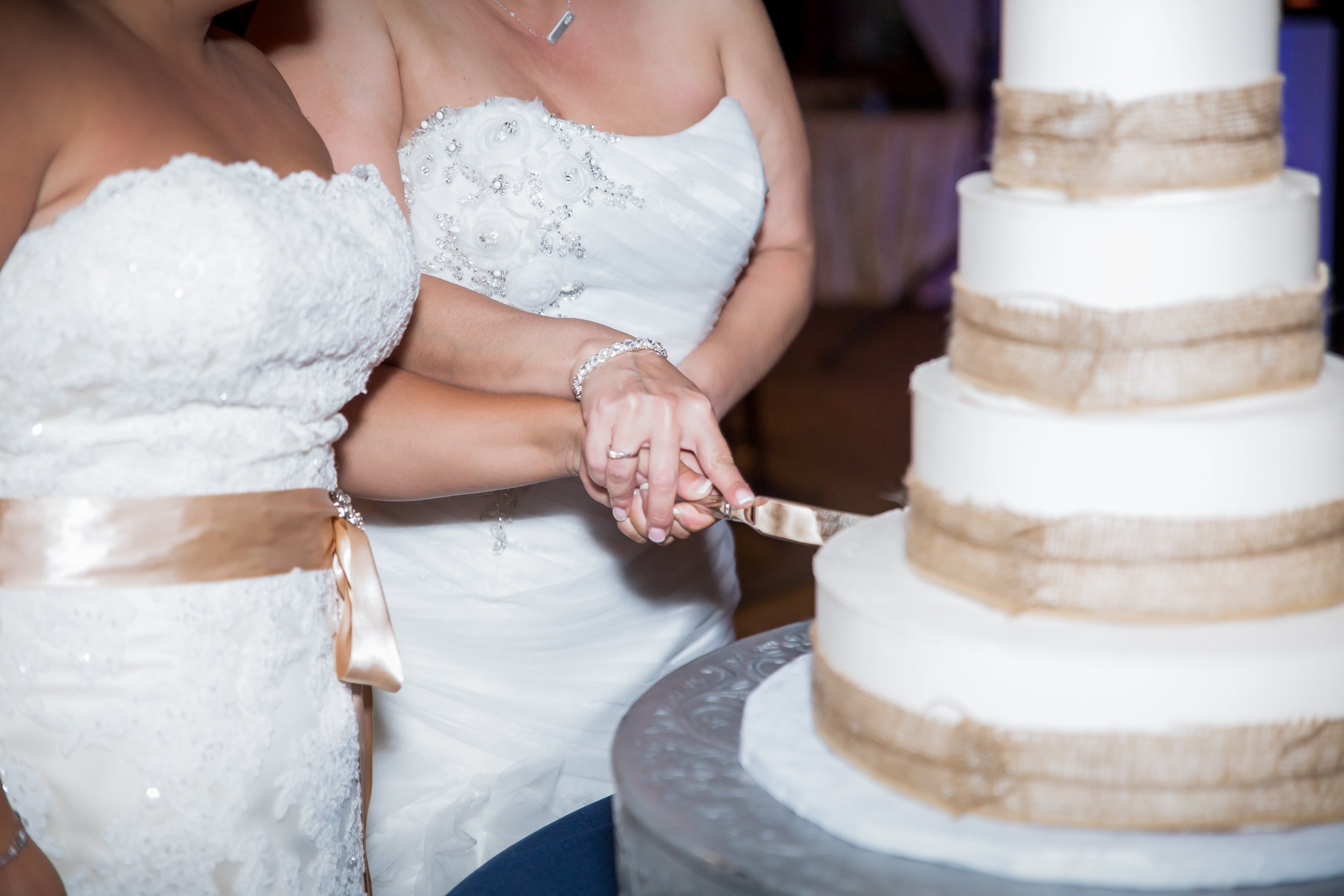 Brides cutting wedding cake