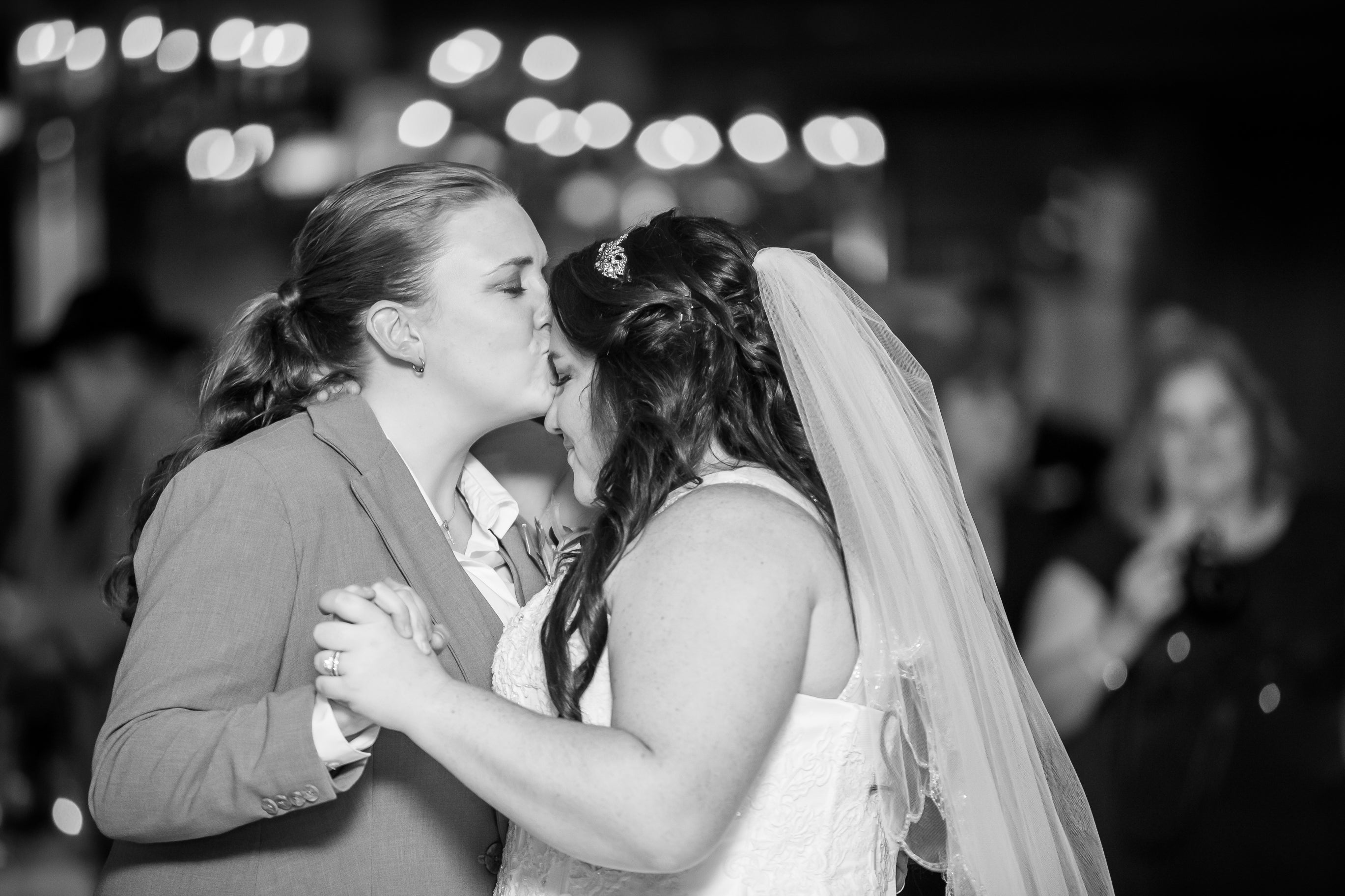 Bride kissing bride on forehead