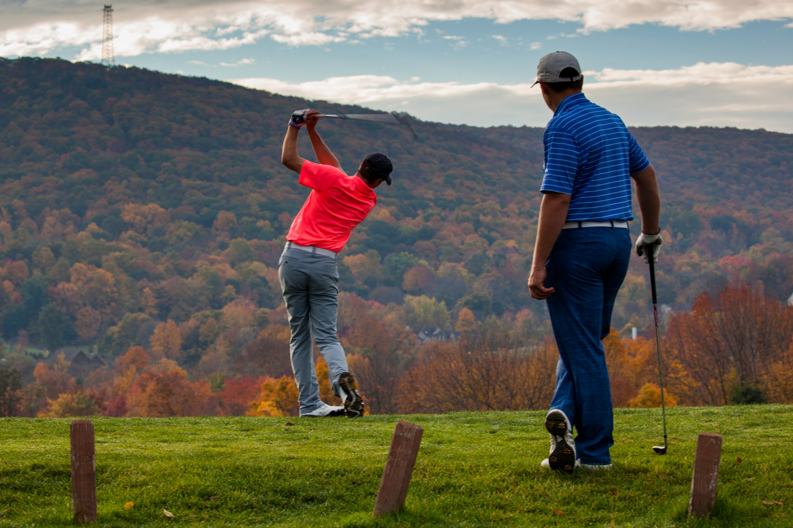 Two men playing golf at Crystal Springs Resort during Fall