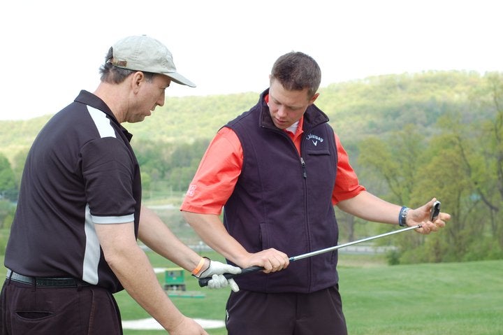 Golf Instructor teaching man to golf at Crystal Springs Resort