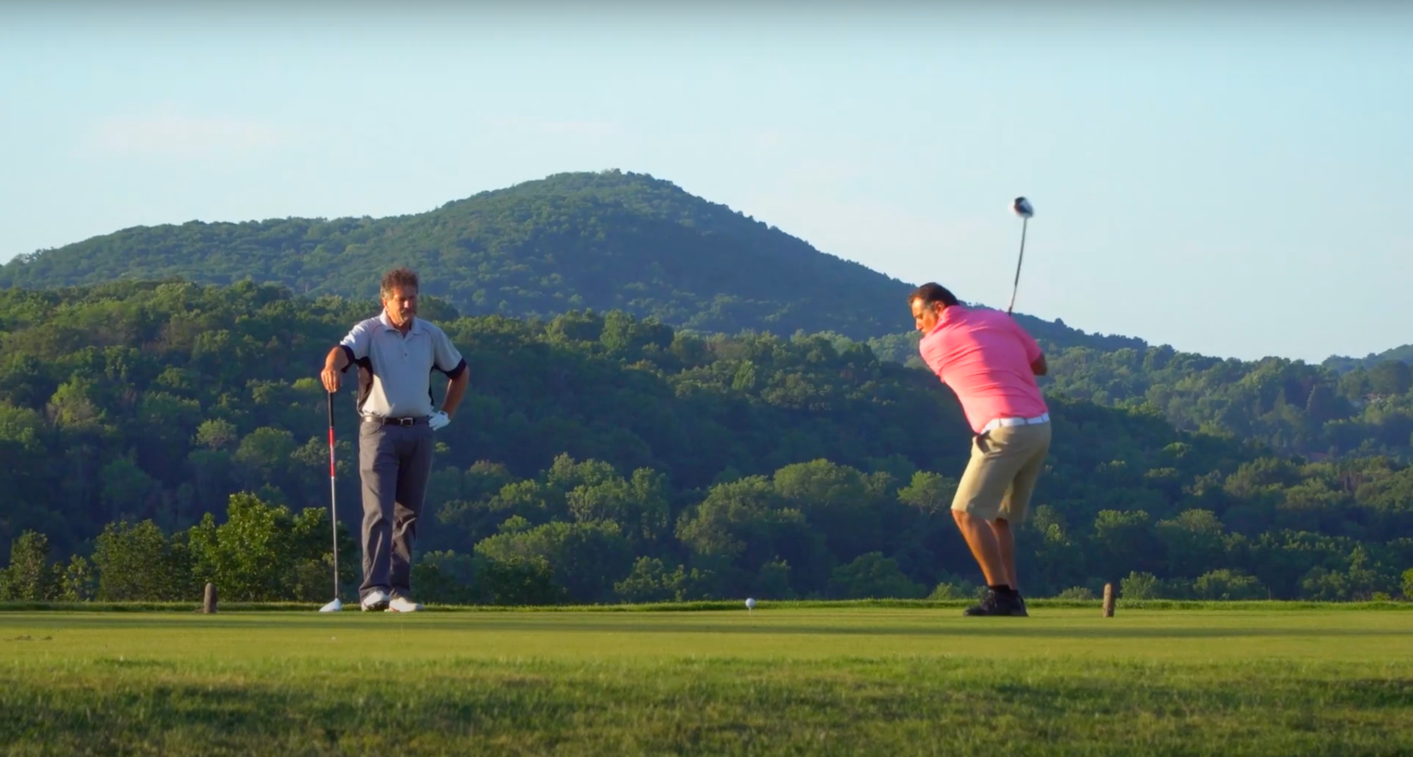Two Golfers making their swings at a golf course near NYC