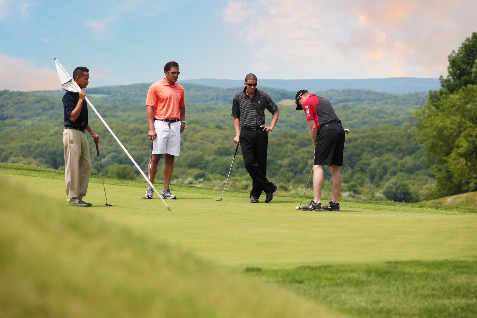 Foursome on the putting green at Wild Turkey golf course