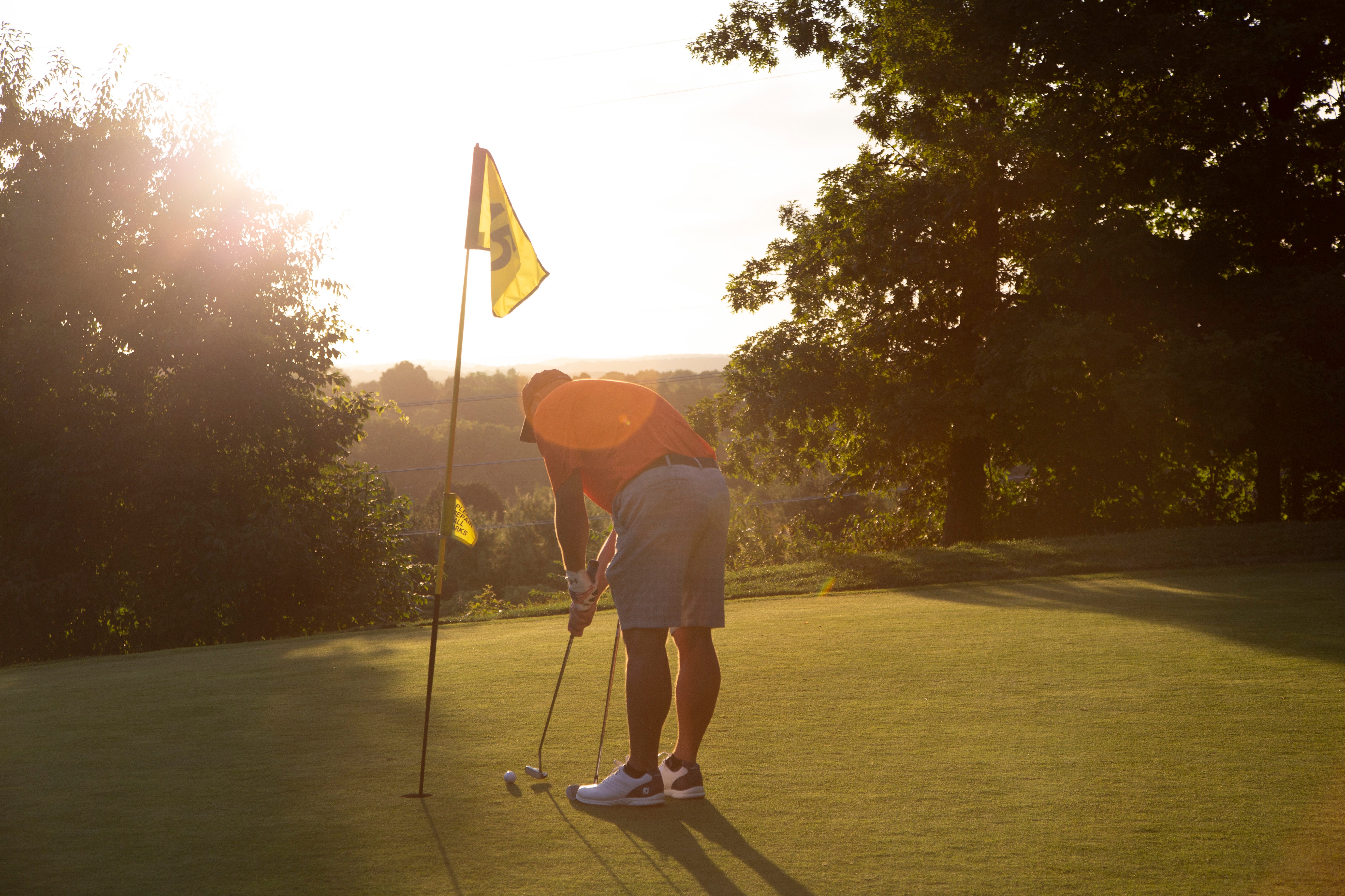 Man making his putt at a hole on Black Bear Golf Course