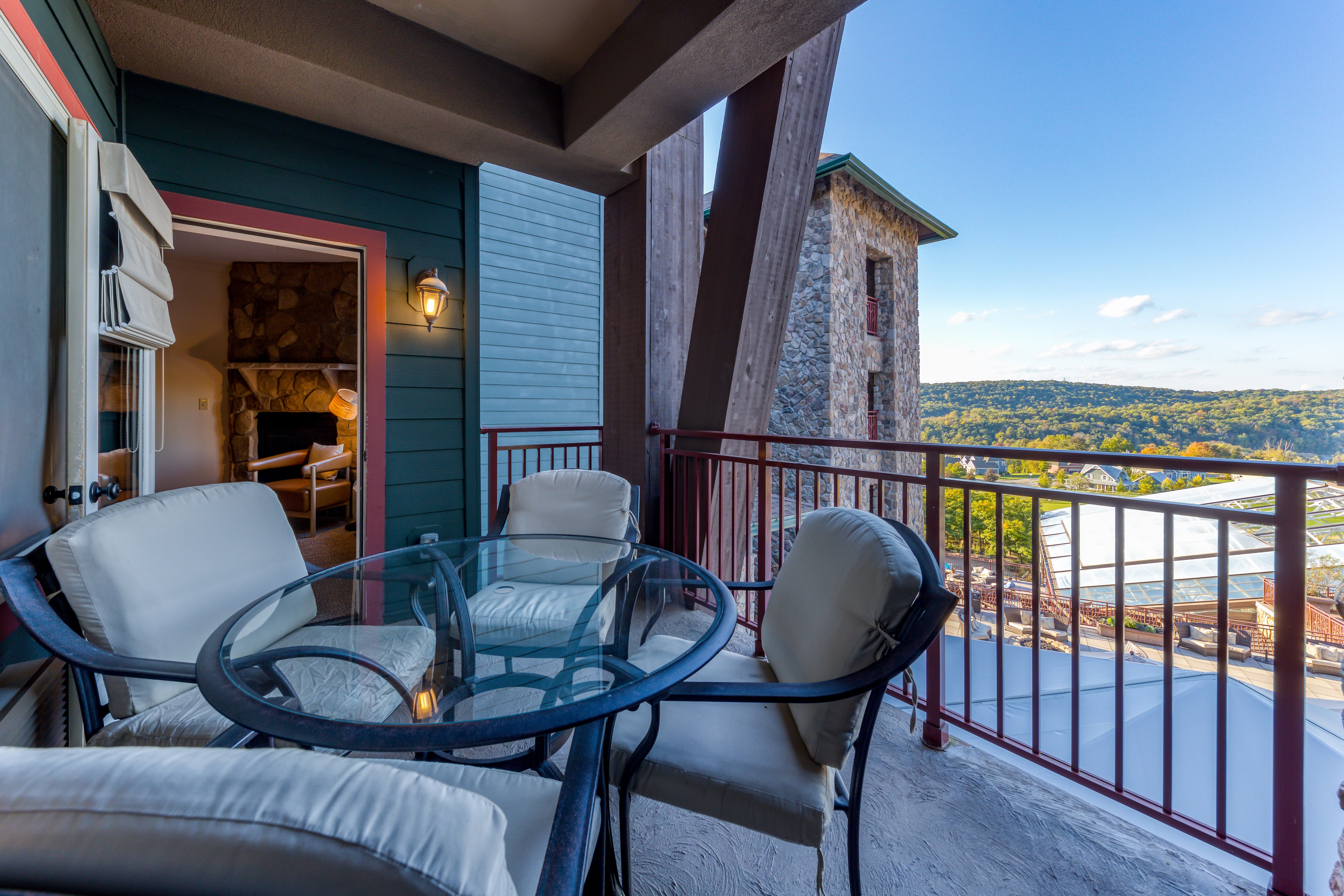 Table and chairs on balcony of Grand Cascades Lodge suite.