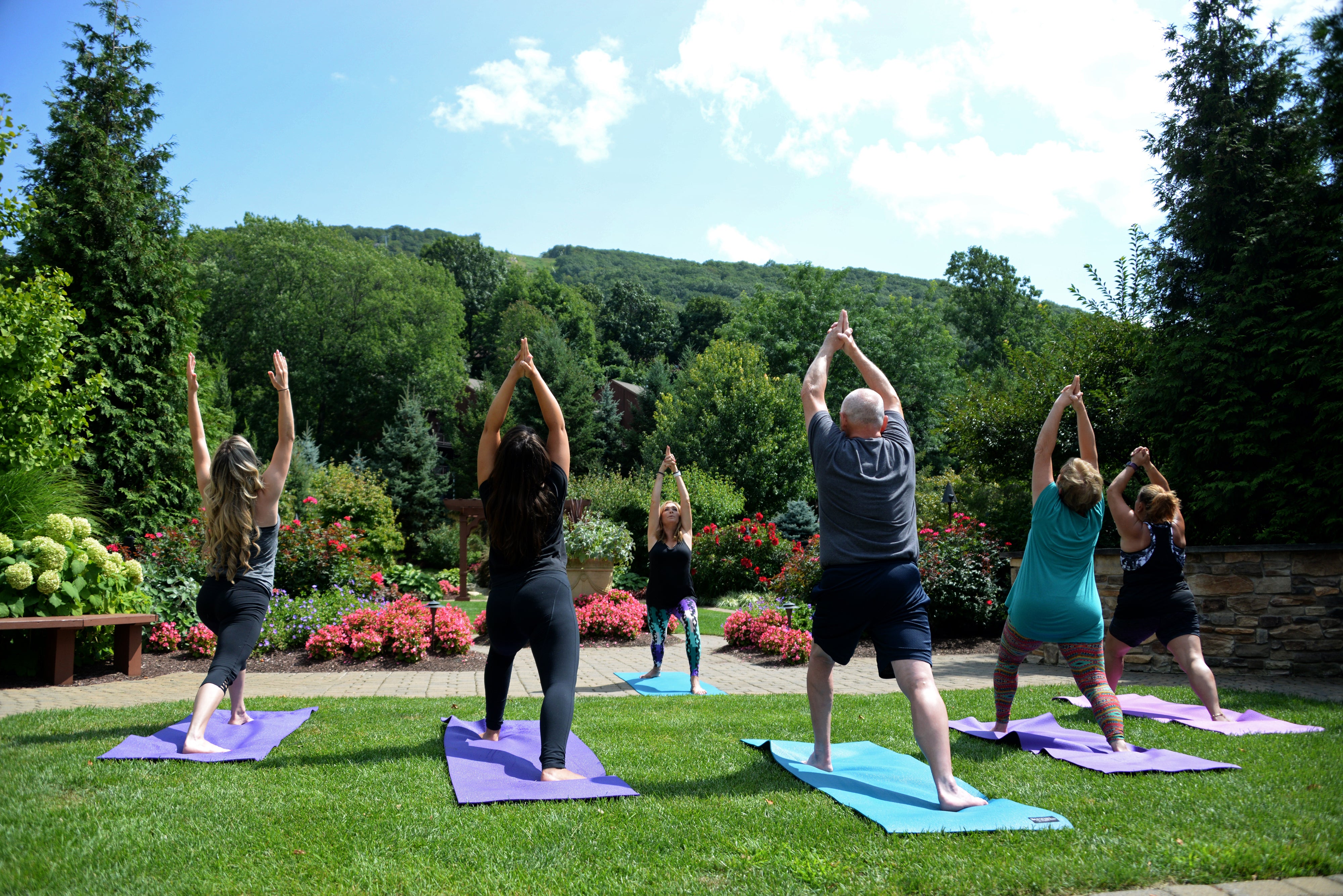  Outdoor Yoga Class surrounded by greenery