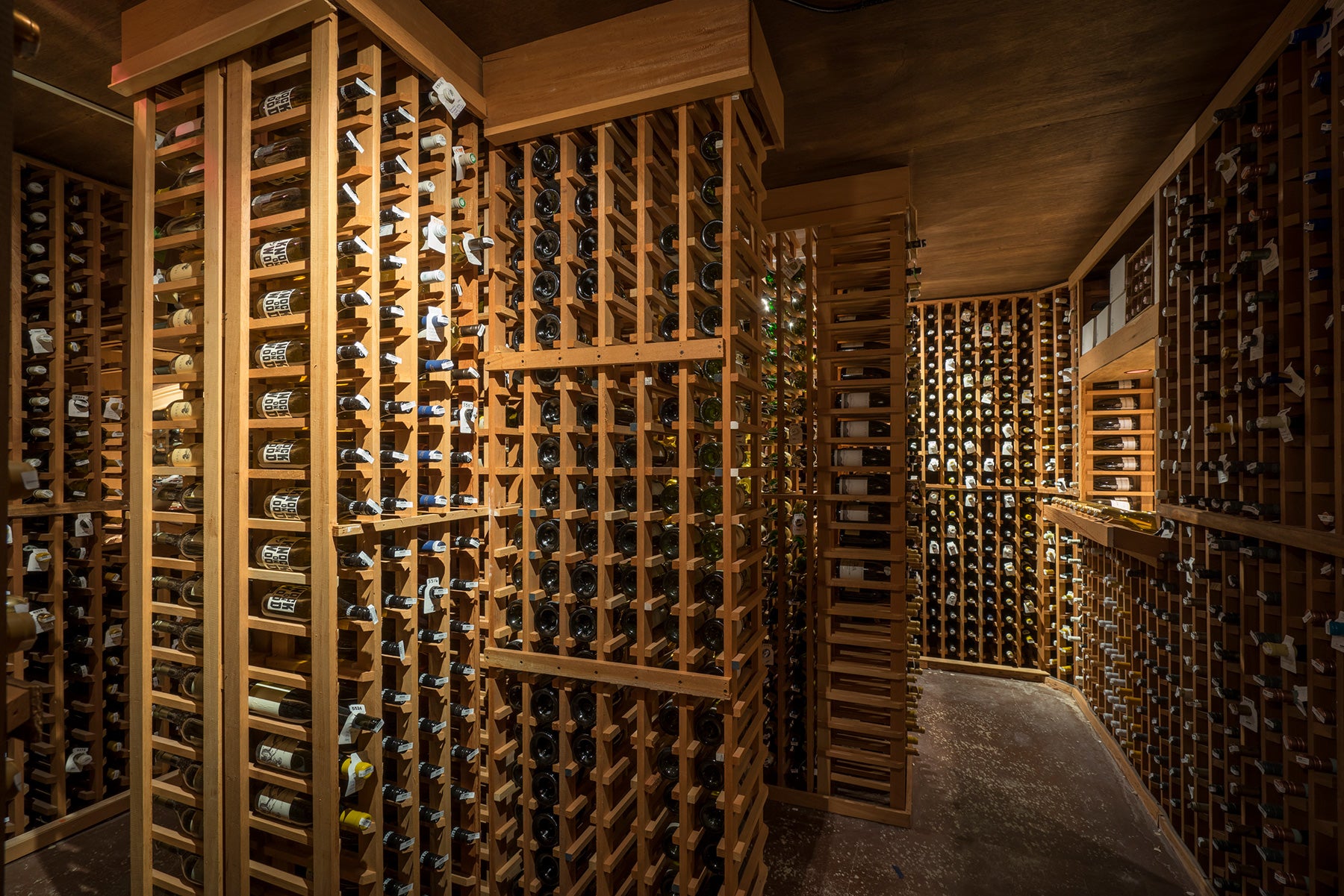 Tall wooden columns filled with wine for display.