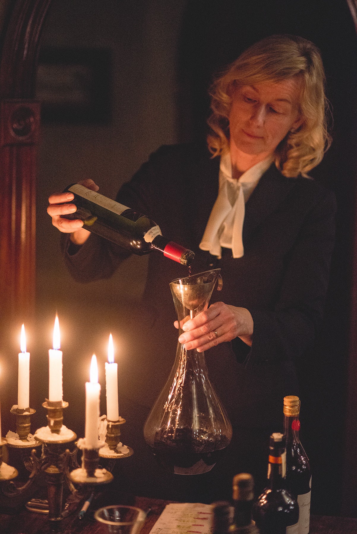 Susanne Wagner pouring wine into a decanter.
