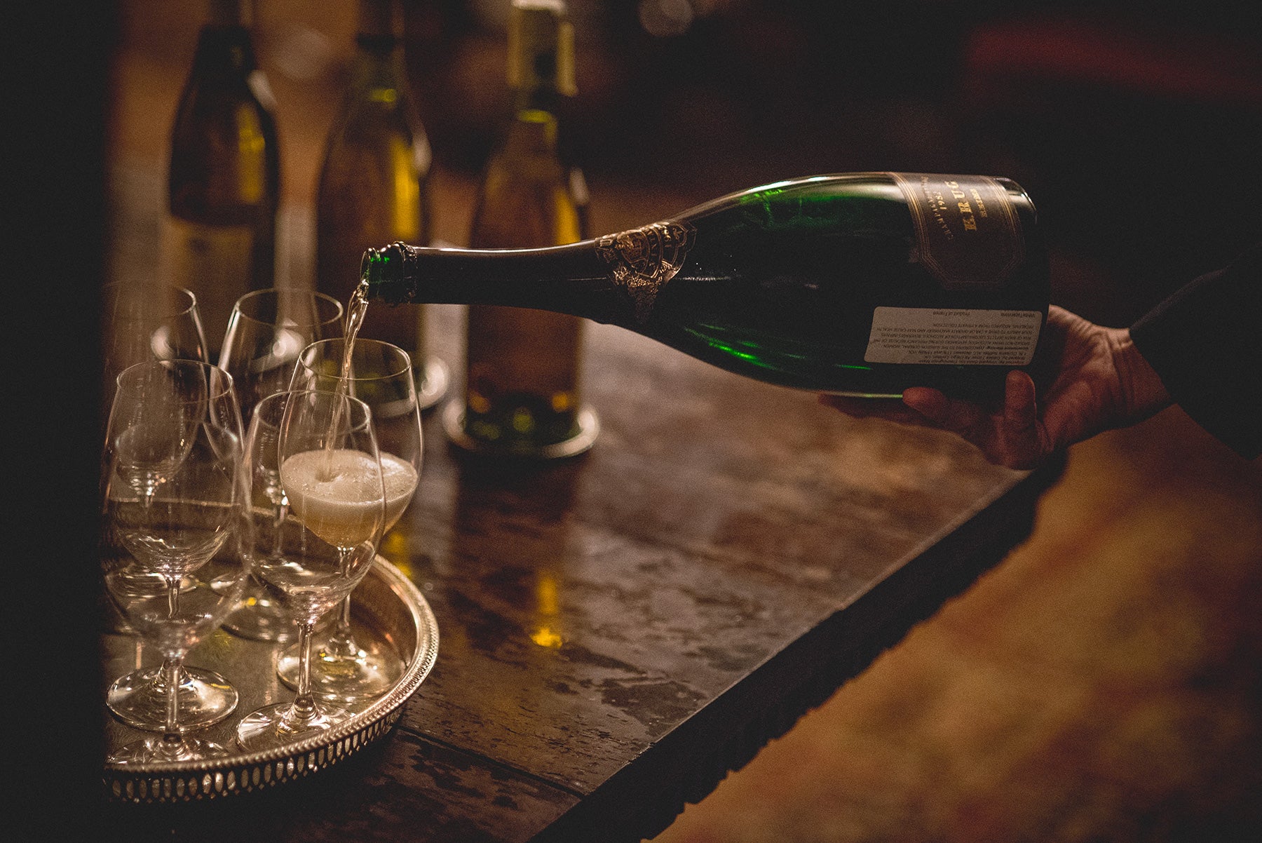 White wine being poured into glasses.