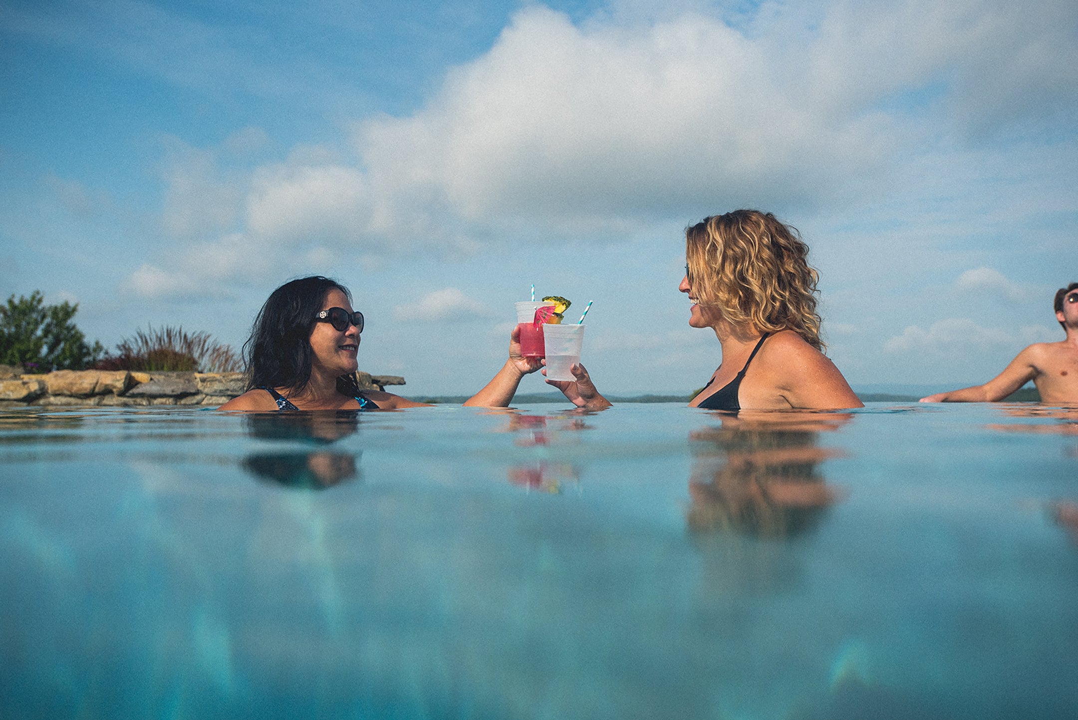 Girlfriends drinking cocktails by the pool at a resort close to NYC