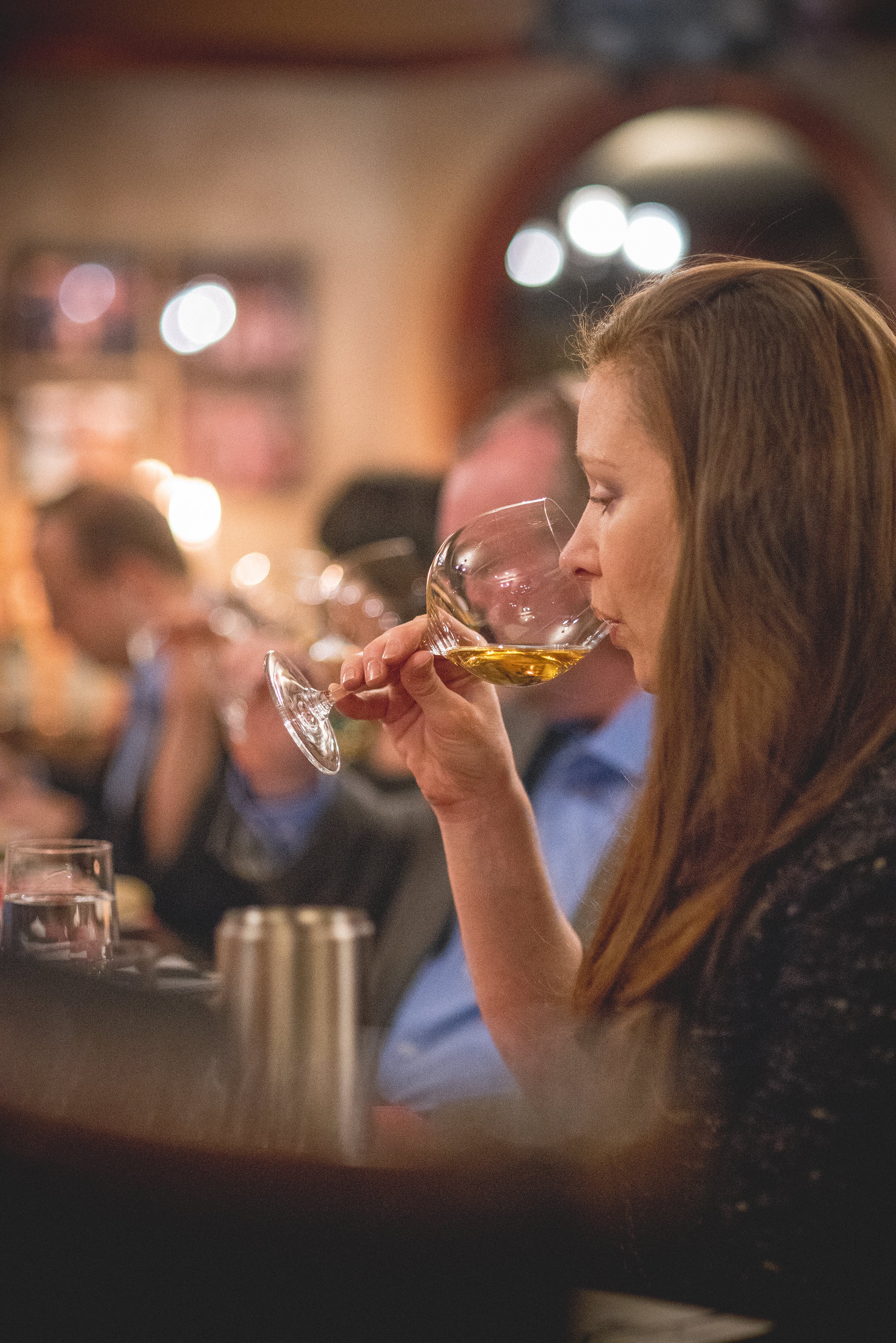 Woman drinking white wine.