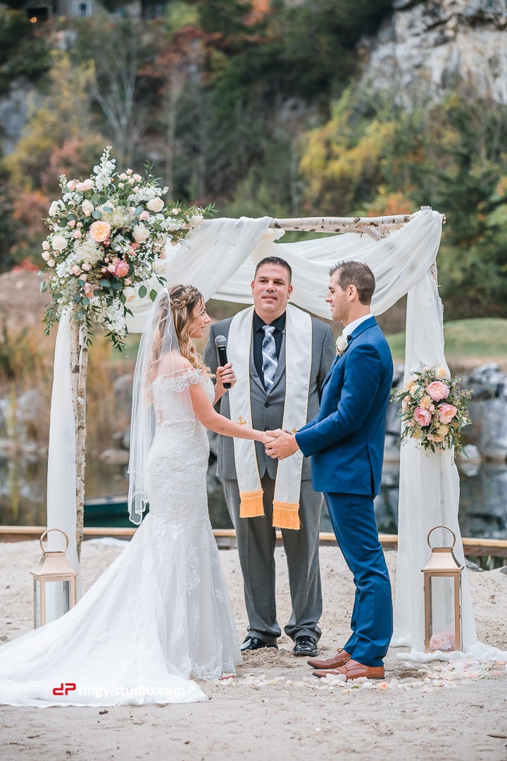 Romantic couple holding hands at the alter