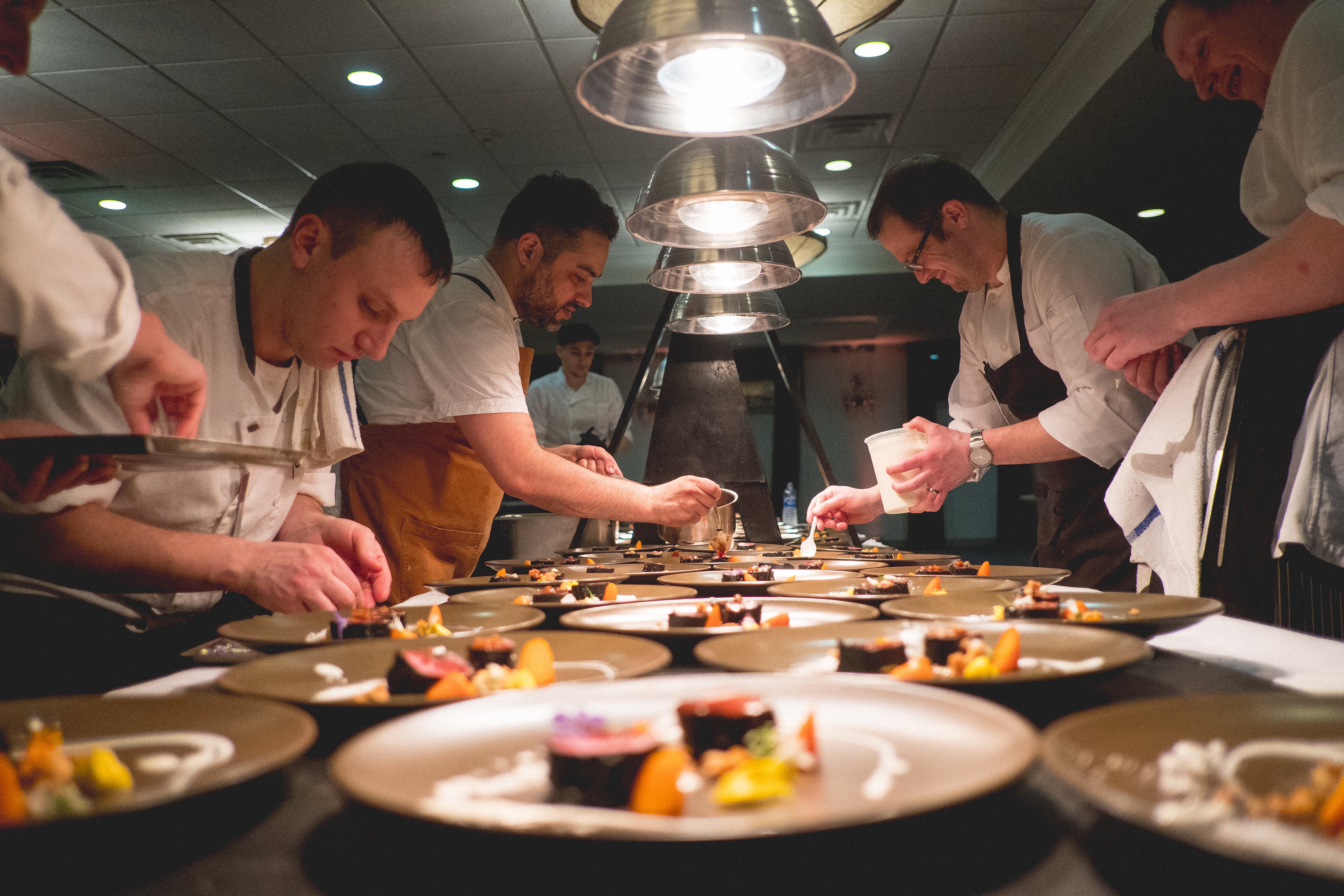 Chefs hard at work plating food at NJ Wine and Food Festival