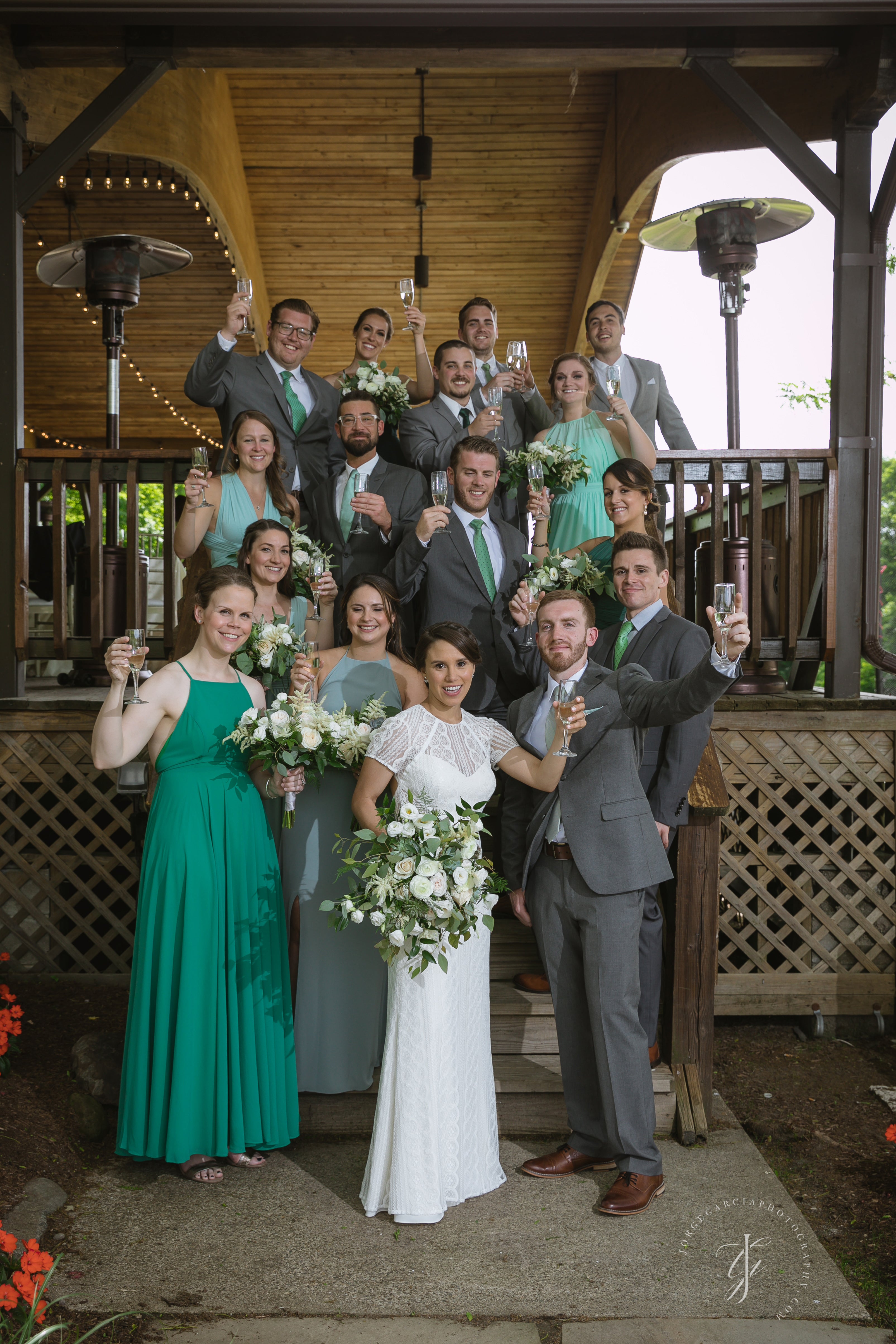 Wedding party making a toast on the stairs of Sweetgrass Pavillion