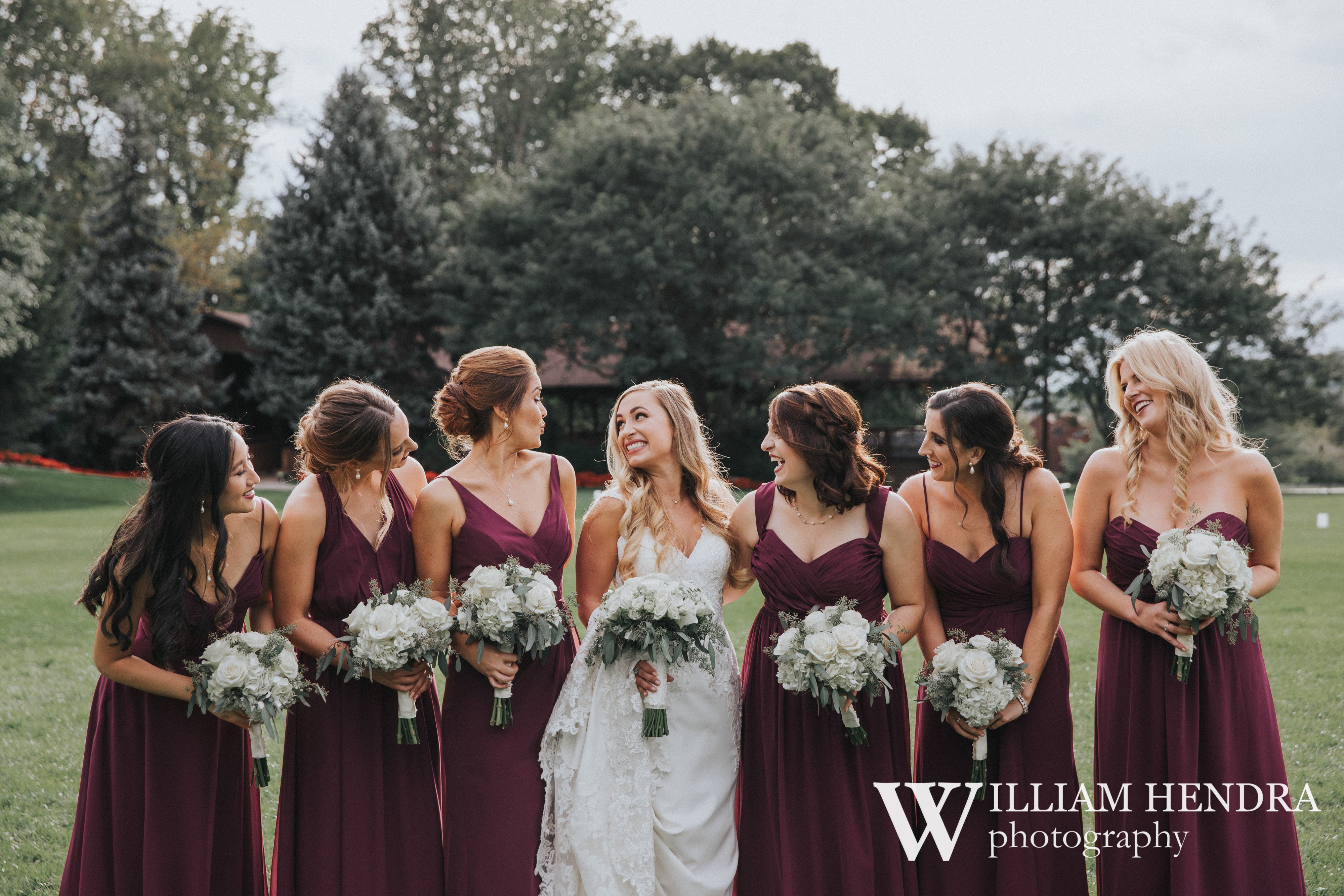 Bride smiling with bridesmaids 