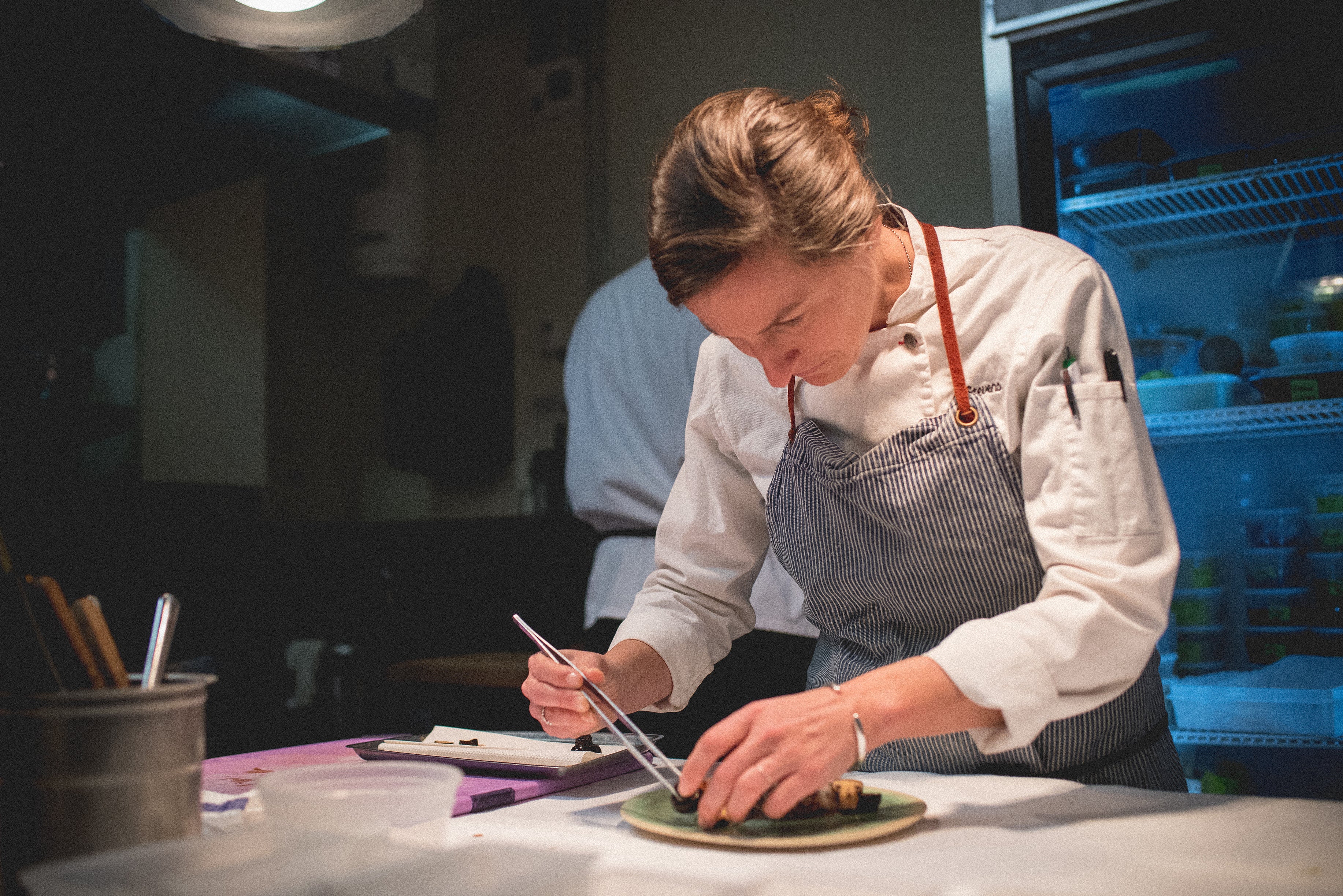 Chef Aishling Stevens plating a dish in Latour