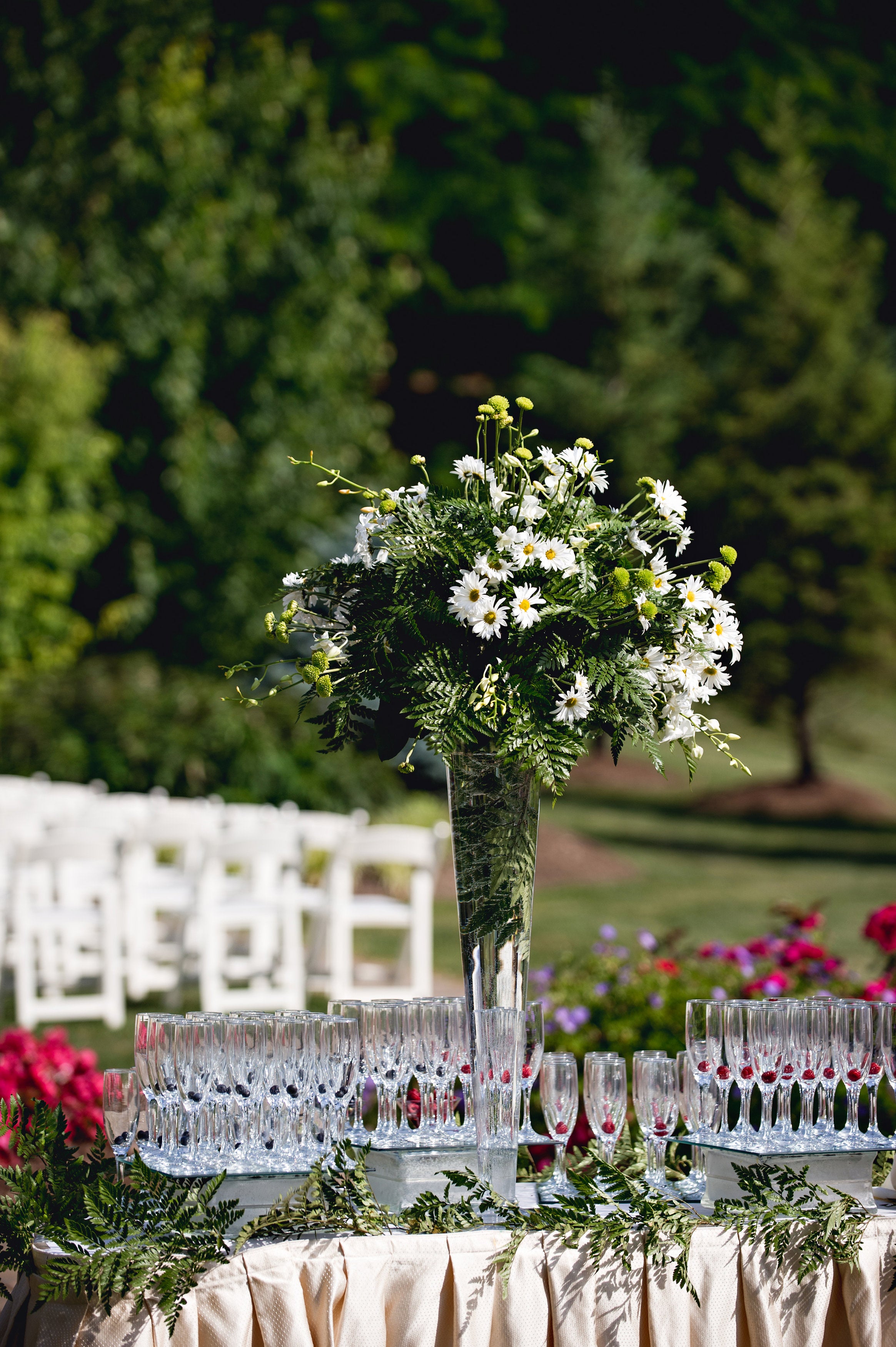 Bouquet of flowers with champagne glasses at wedding cocktail hour