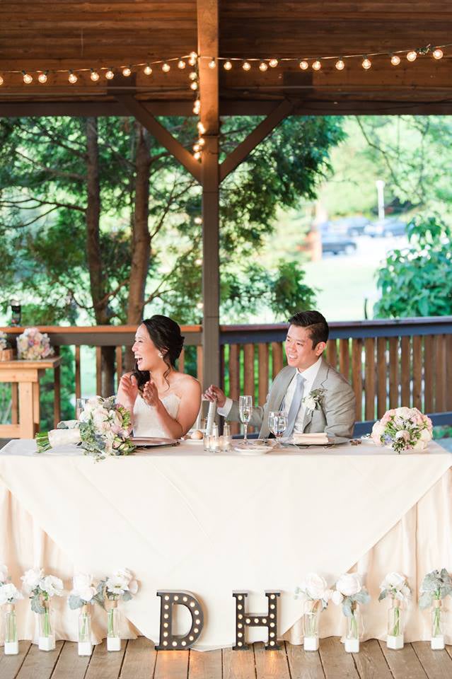 Wedding couple at sweetheart table at Sweetgrass Pavillion
