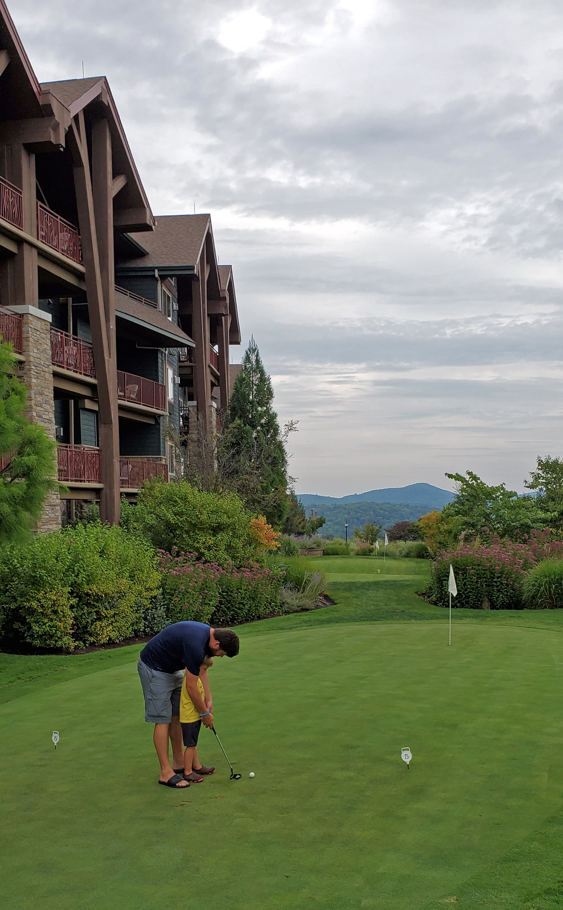 Dad Teaching Son to Golf on Practice Putting Course at Crystal Springs Resort