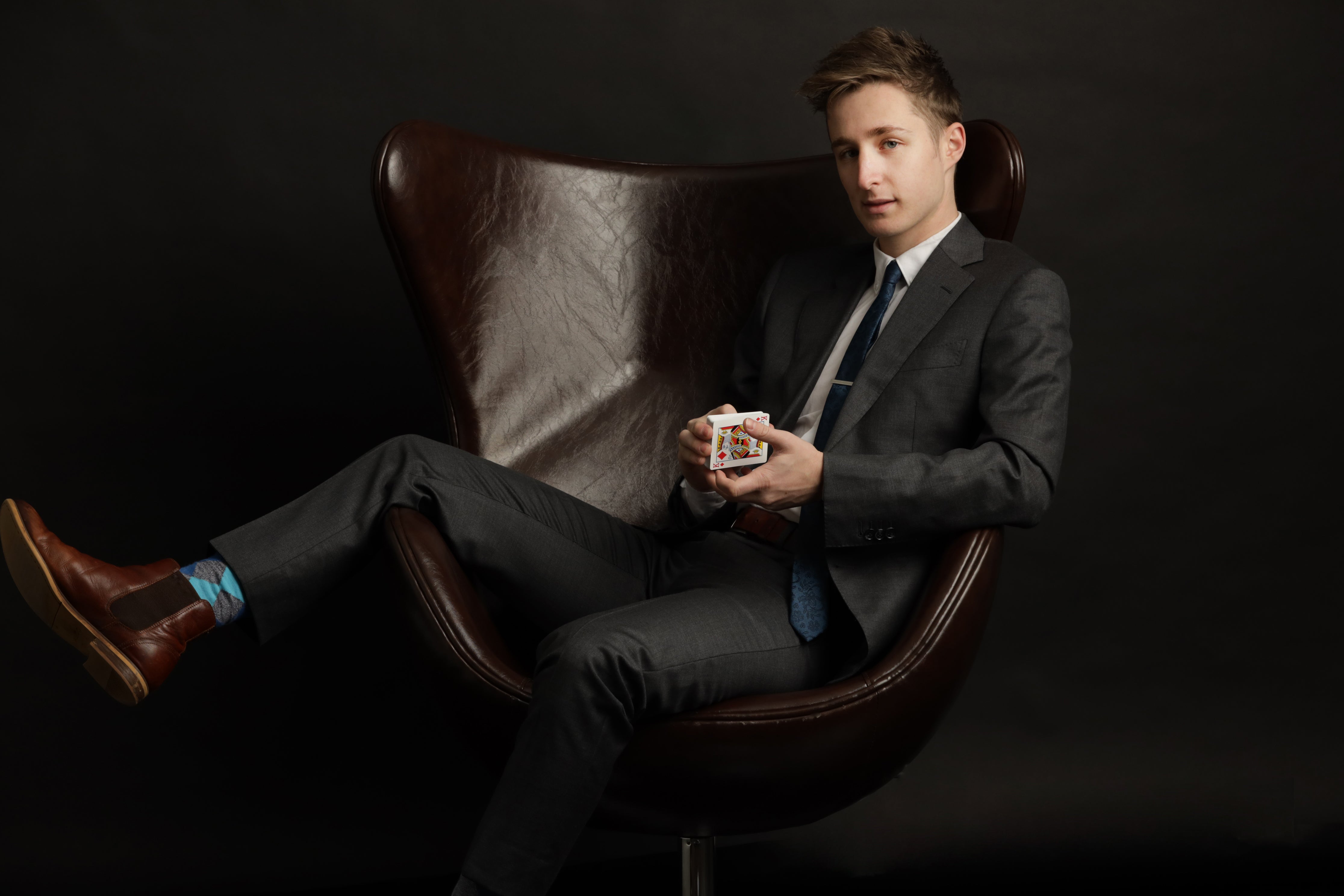 Man sitting in brown leather chair.