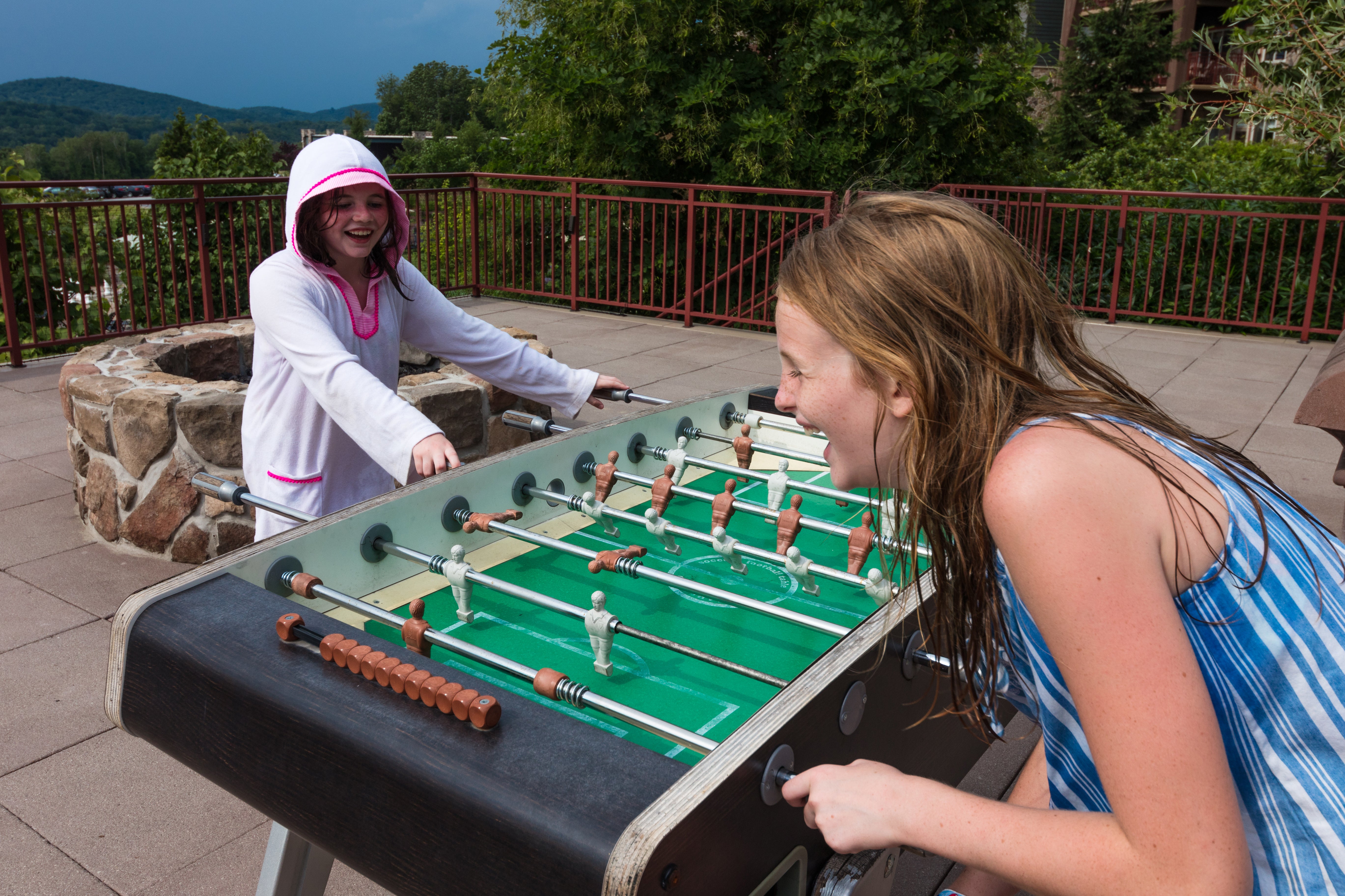 Two children playing foosball.