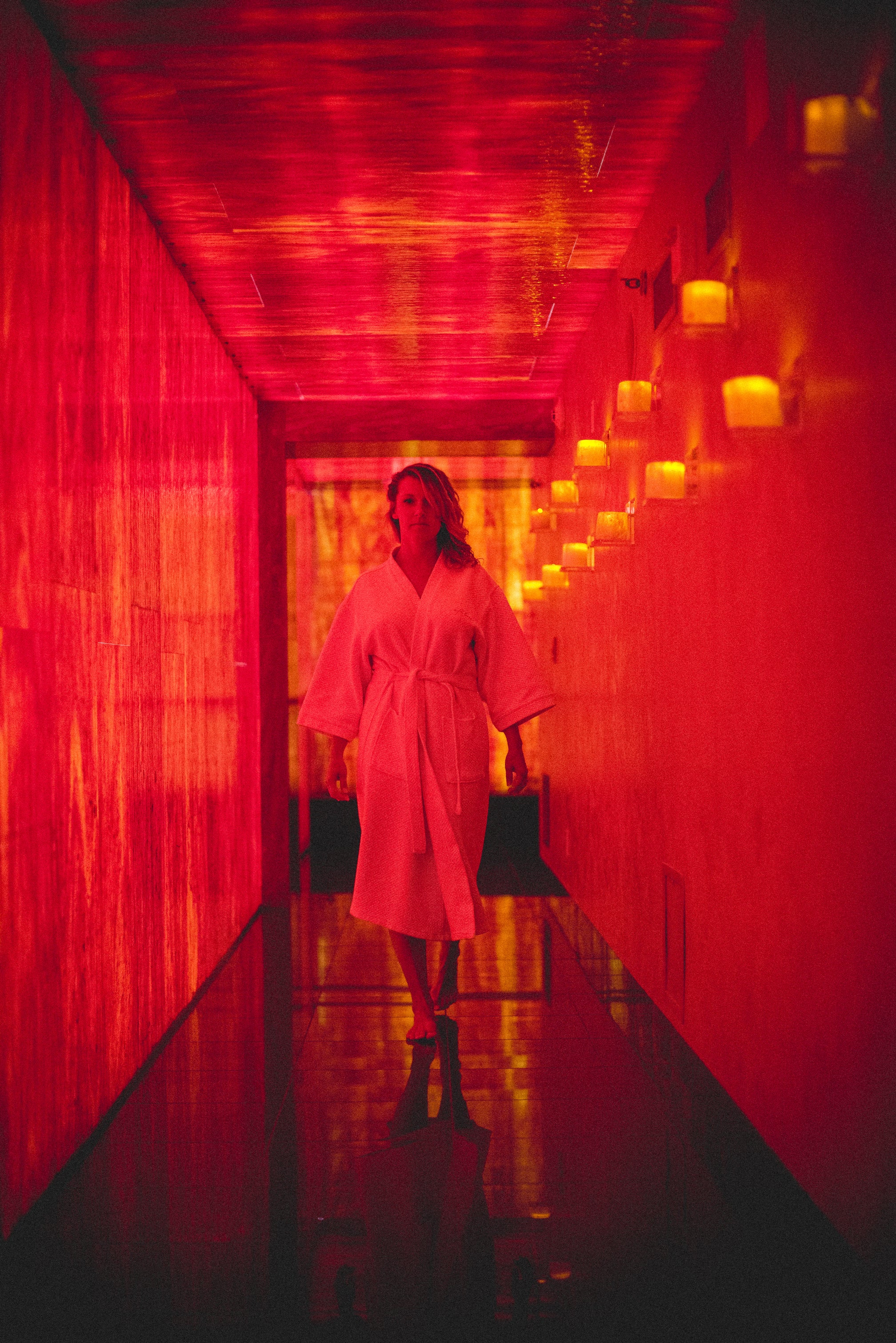 Woman walking down Reflections Spa hallway.