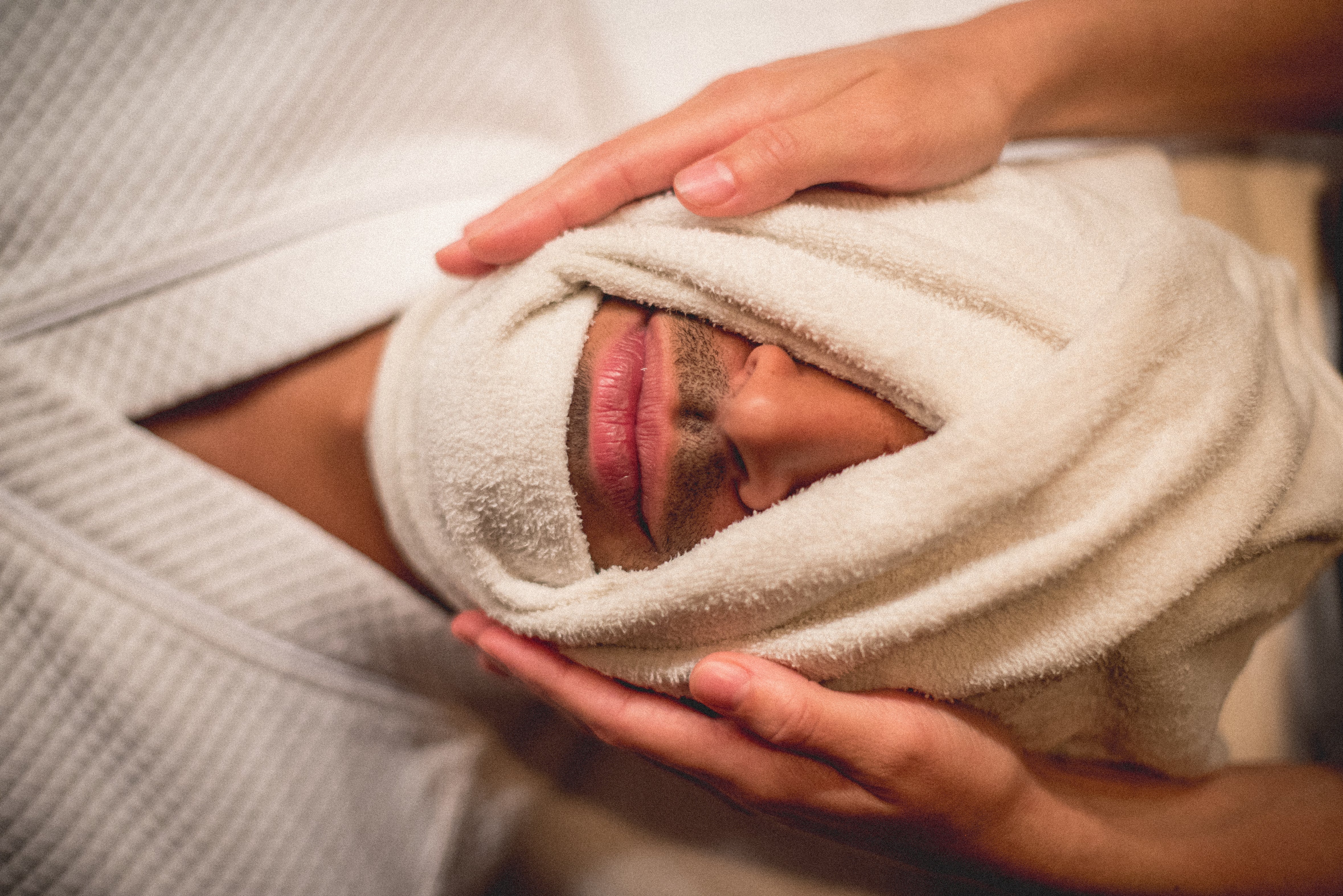 Towel wrapped around man's face