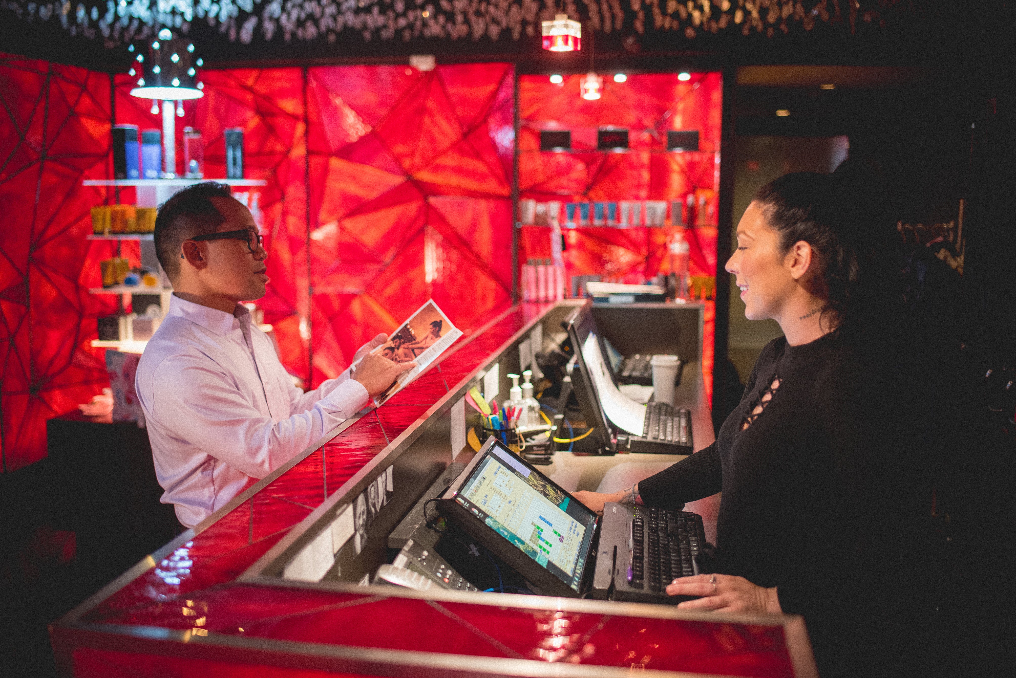 Guest standing at Reflections Spa counter
