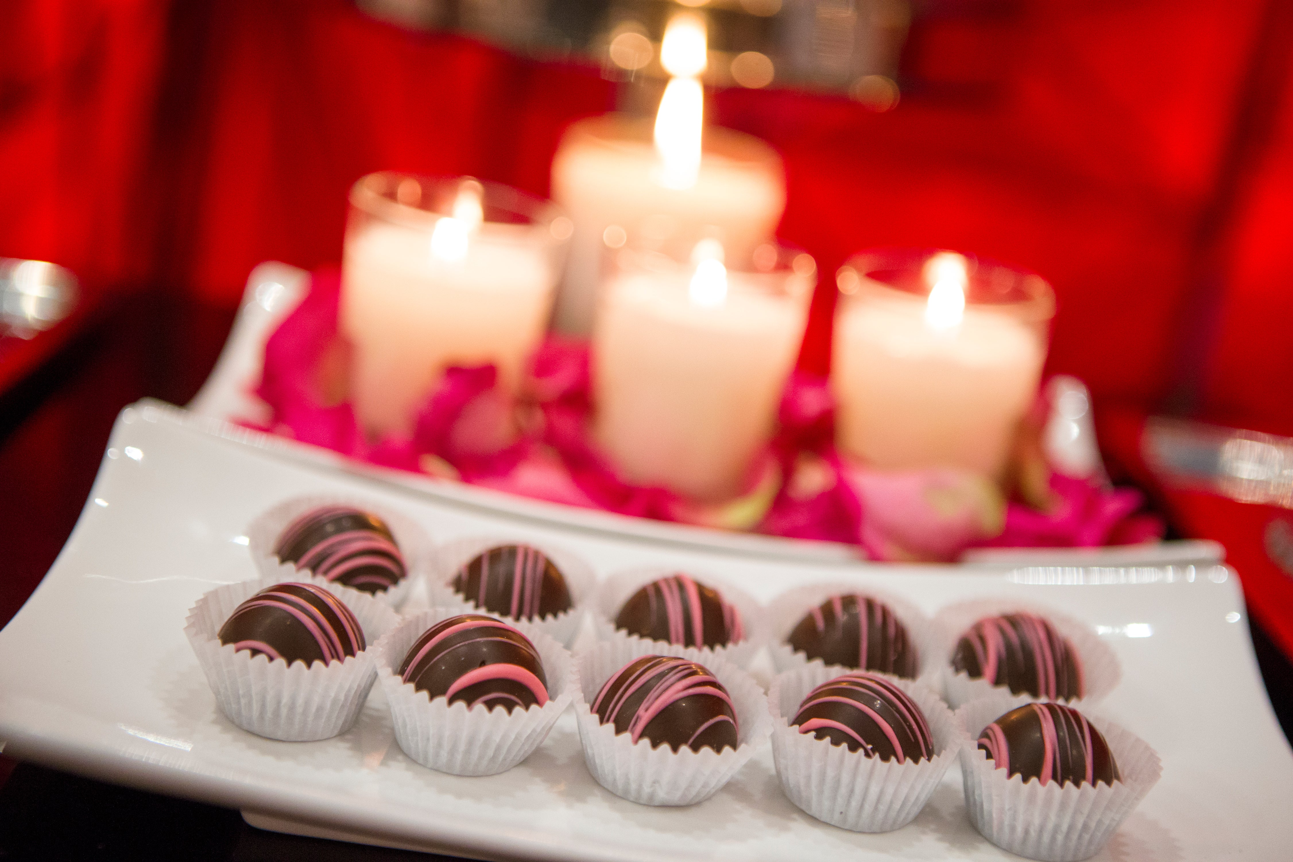 Chocolates with lit candles behind.