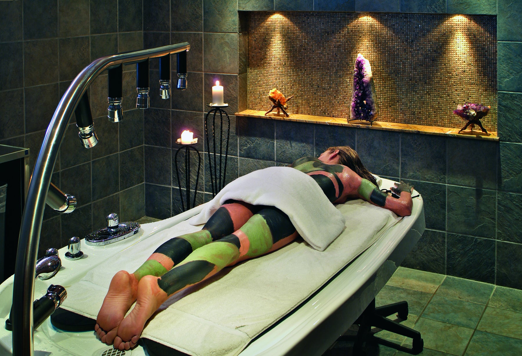 Woman receiving spa mud body treatment.