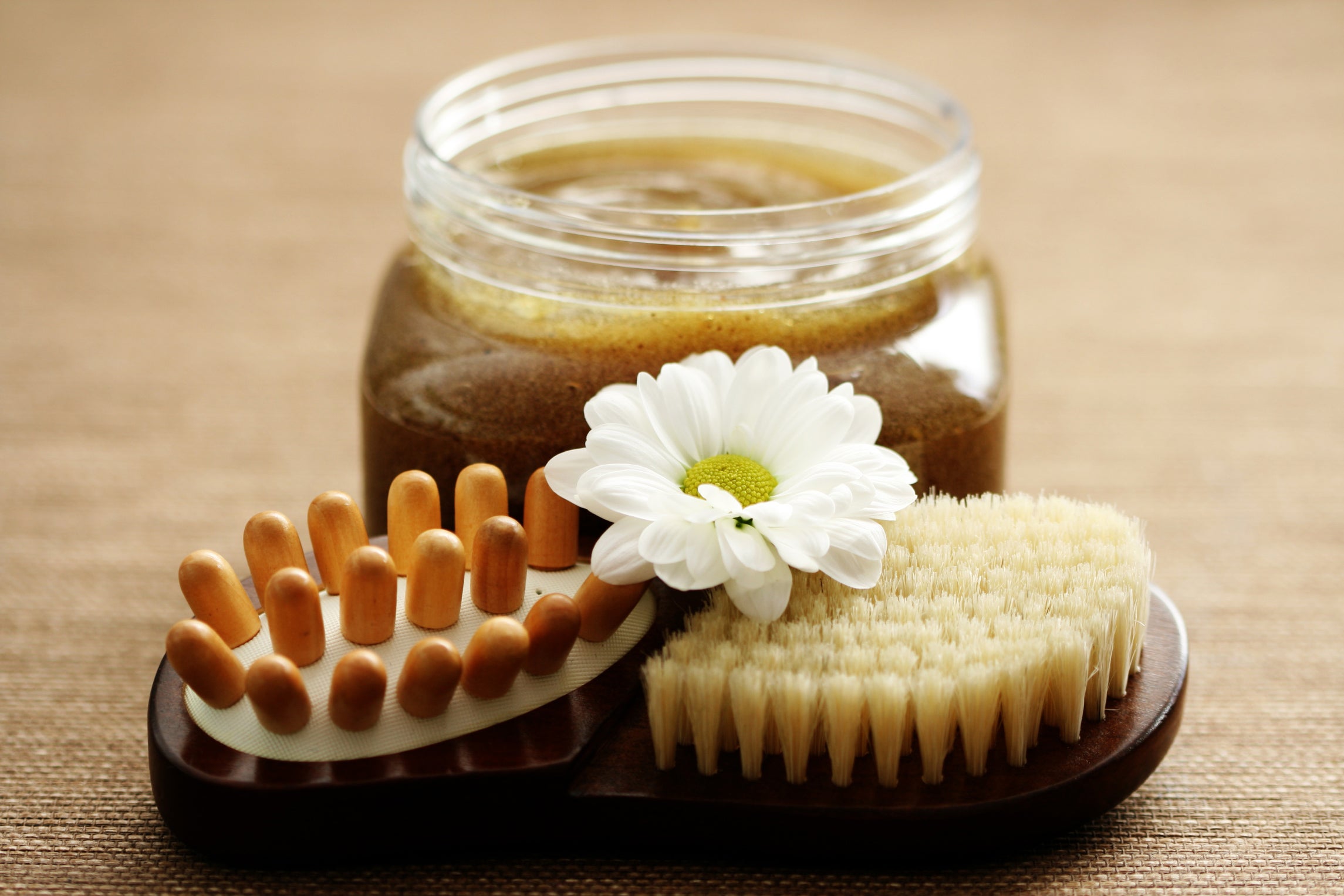 Body scrub container wth body scrub brush.