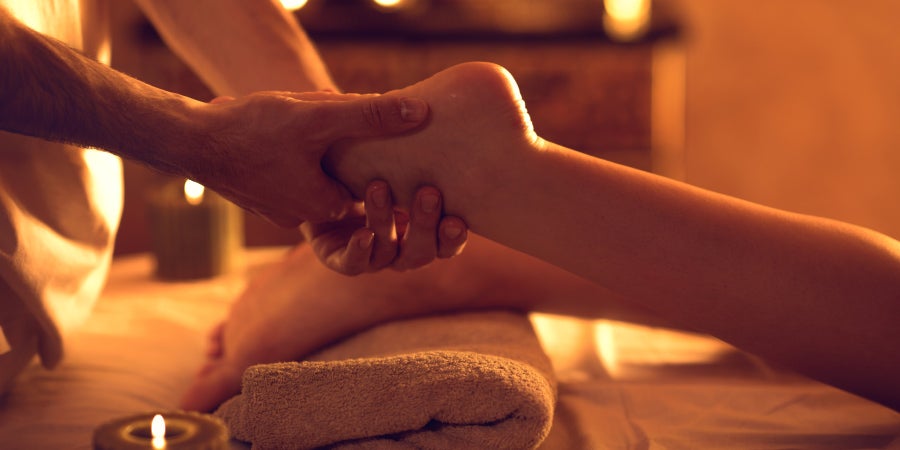 Reflexology massage on foot.