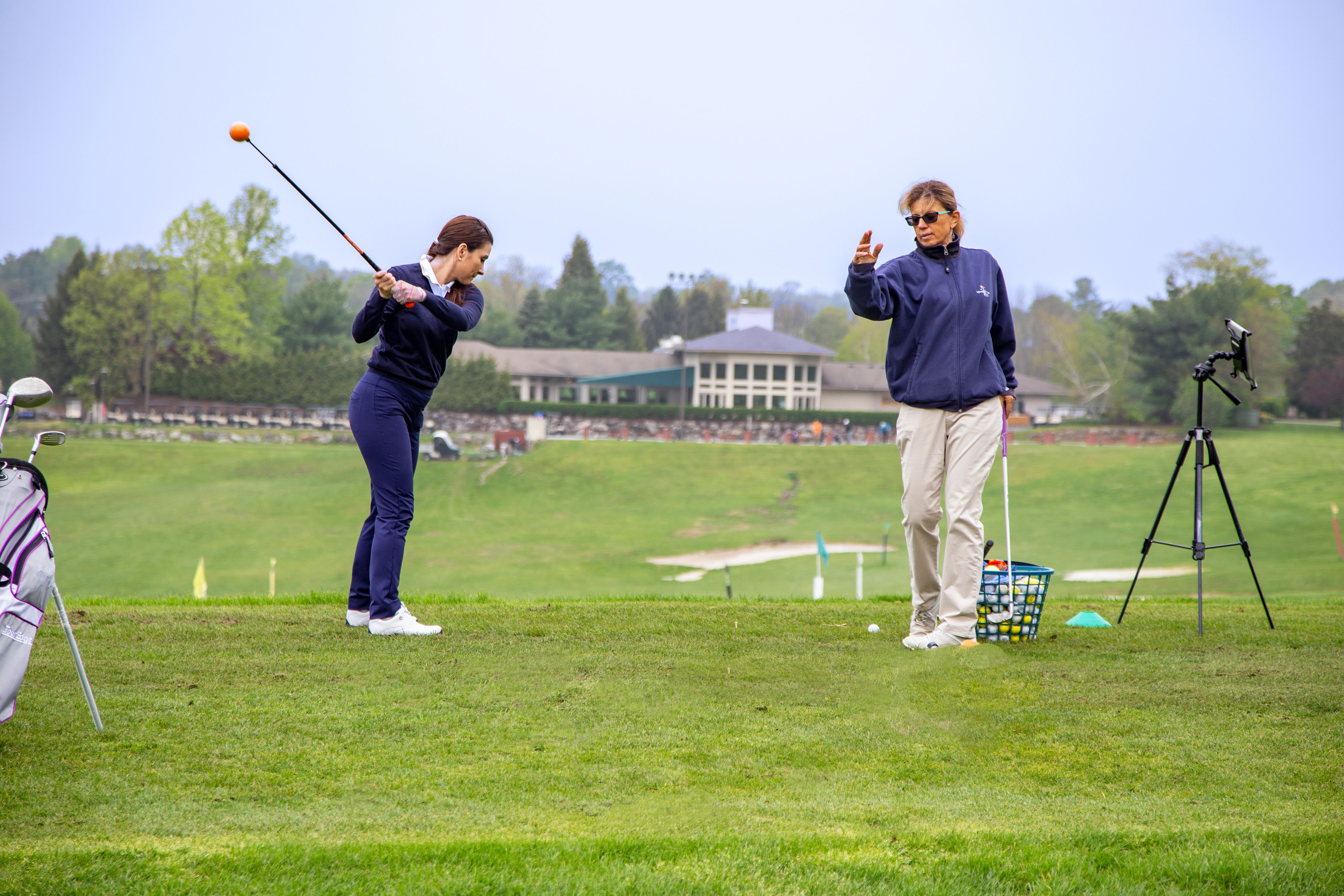 Girl learning to golf by instructor at Leadbetter Golf Academy