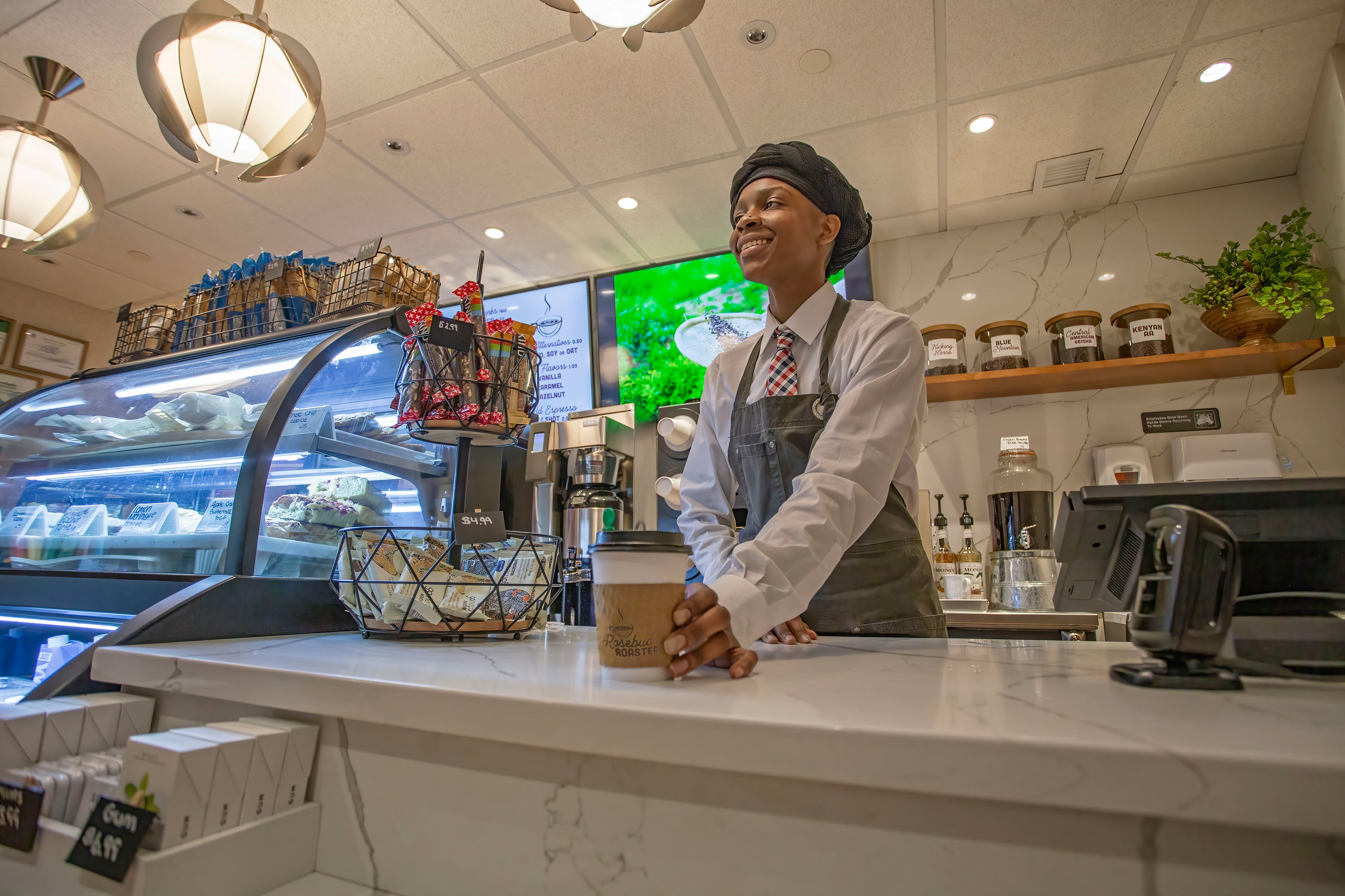 Rosebud Roasters barista serving coffee