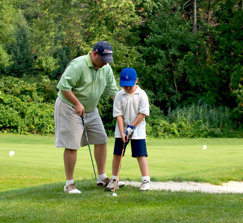 Father and son near a bunker at a golf course at Crystal Springs Resort