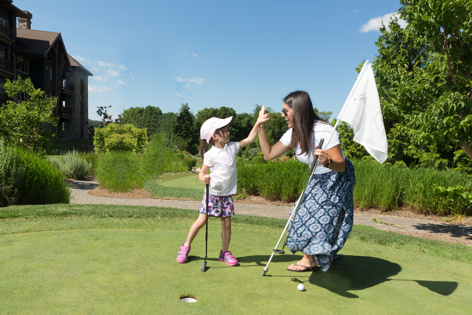 Mother and daughter at the natural grass putting course at Grand Cascades Lodge