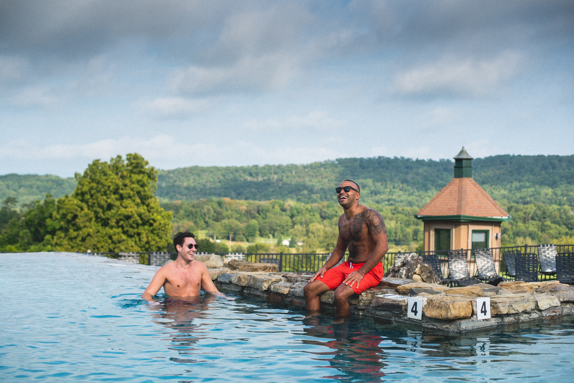 Two men relaxing in Vista 180 pool.