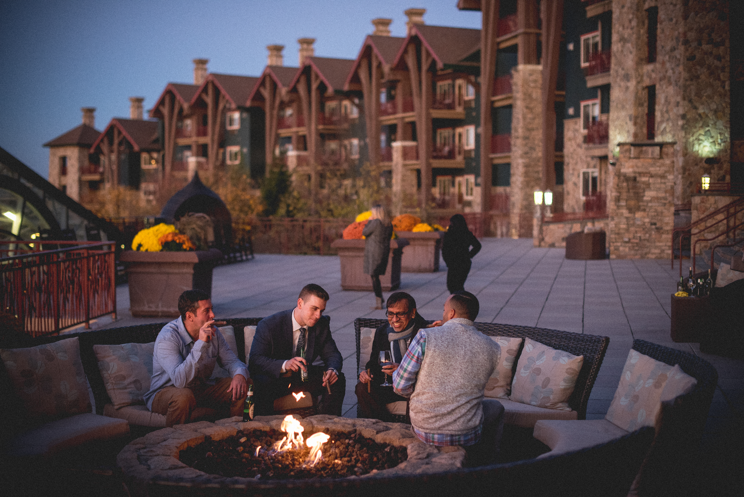 Corporate guys hanging out by a fire pit at Grand Cascades Lodge