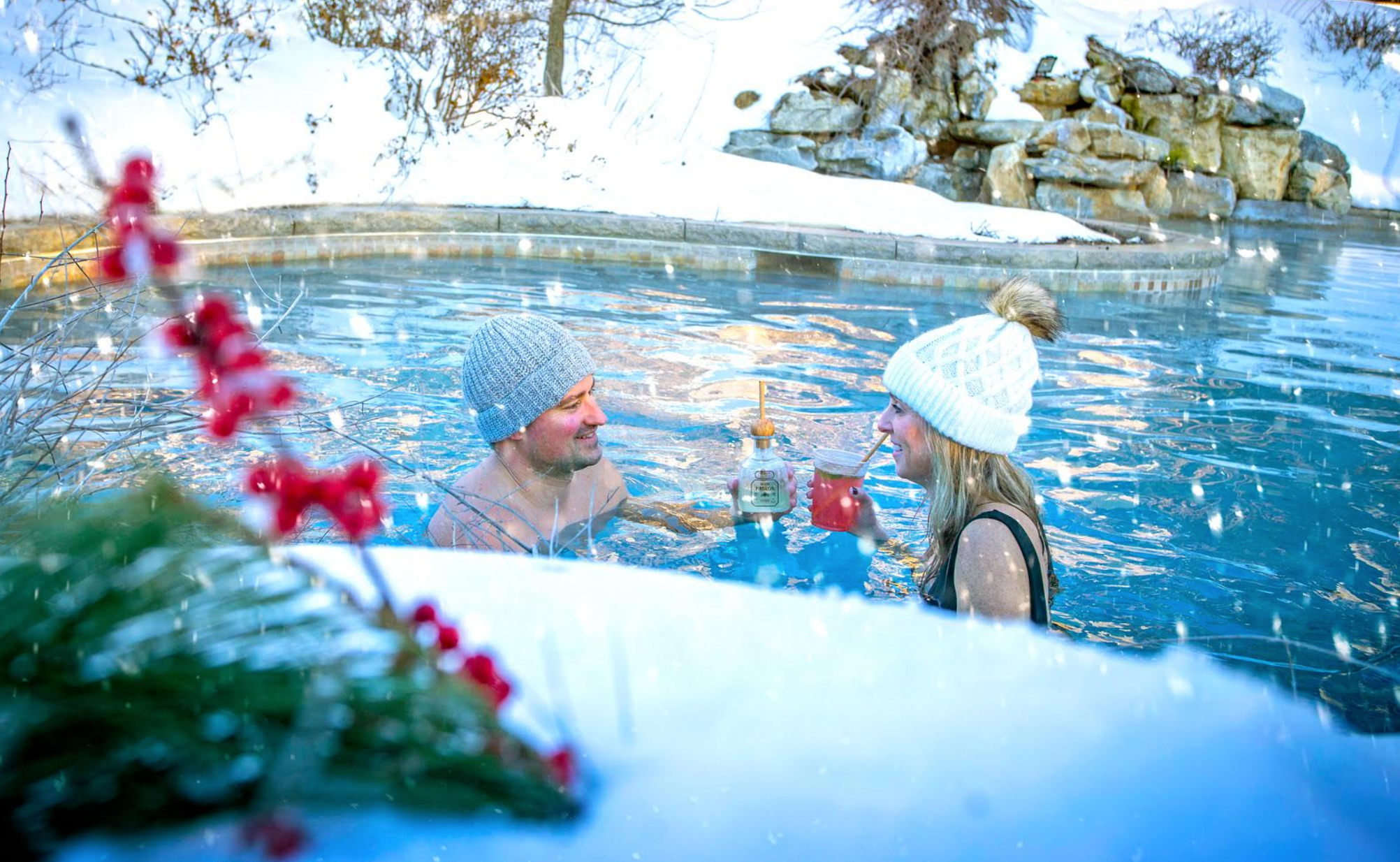 A couple enjoying drinks in an outdoor pool at Crystal Springs Resort