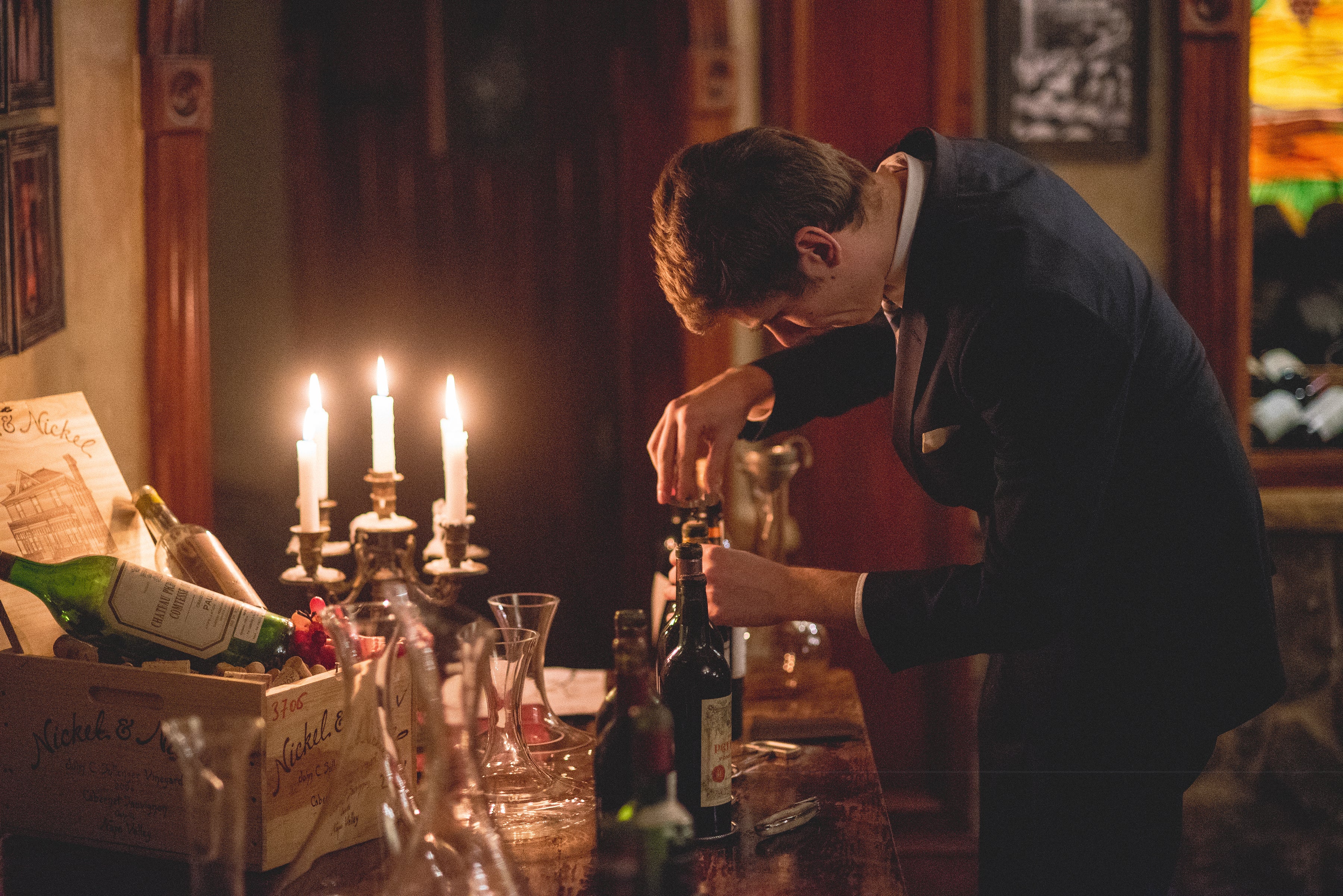 Opening a bottle of wine in the cellar