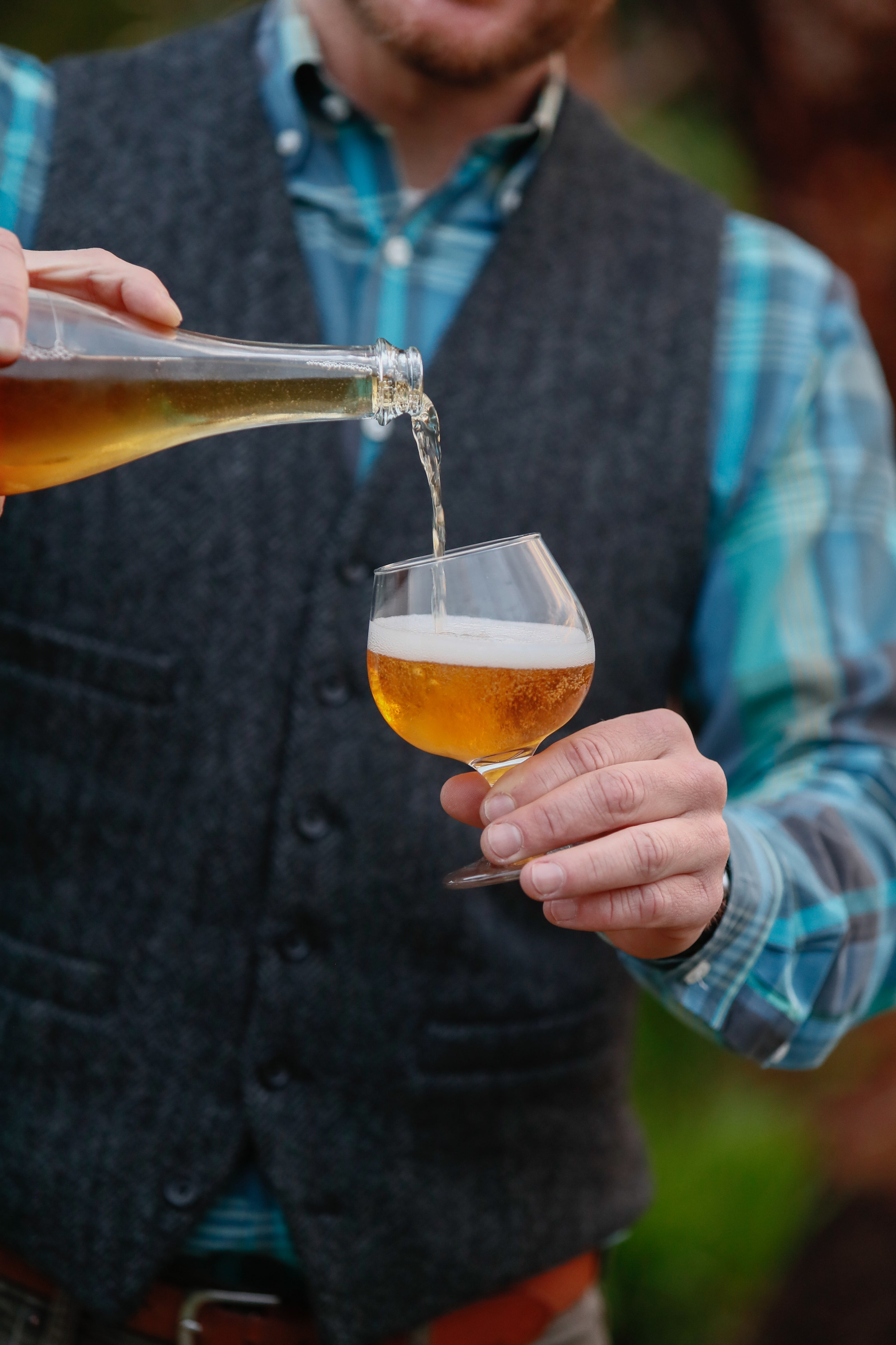 Pouring hard cider into a glass