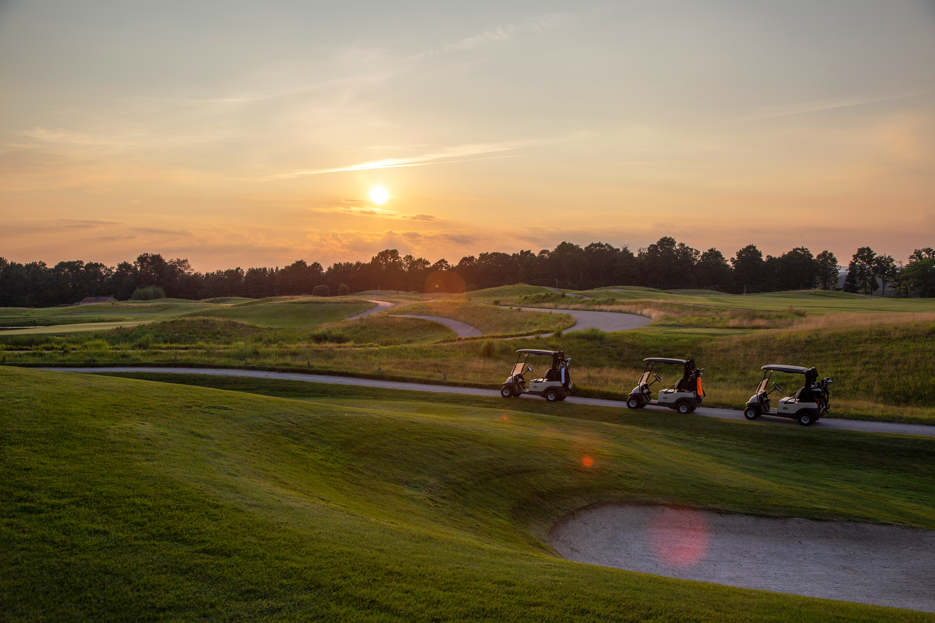 Golf carts on the Ballyowen golf course at sunset