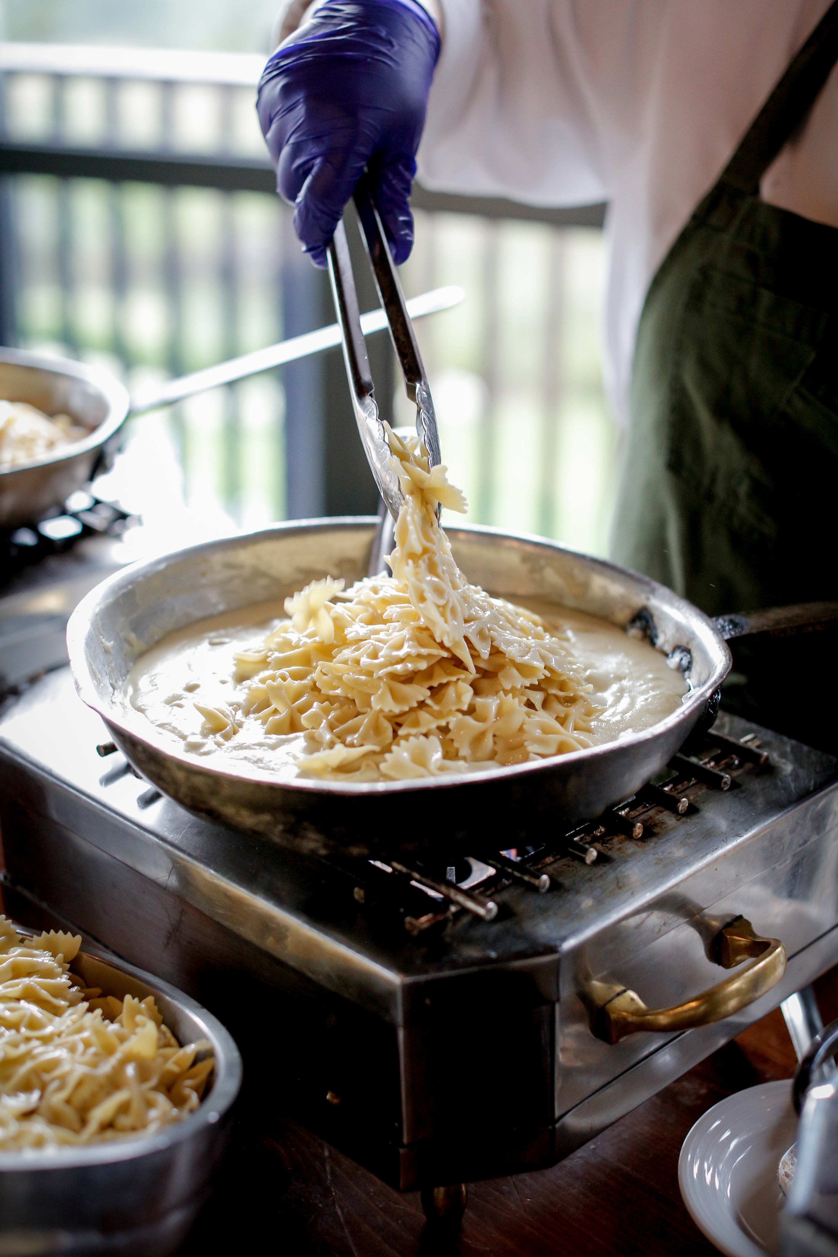 Chef cooking fresh Alfredo pasta 