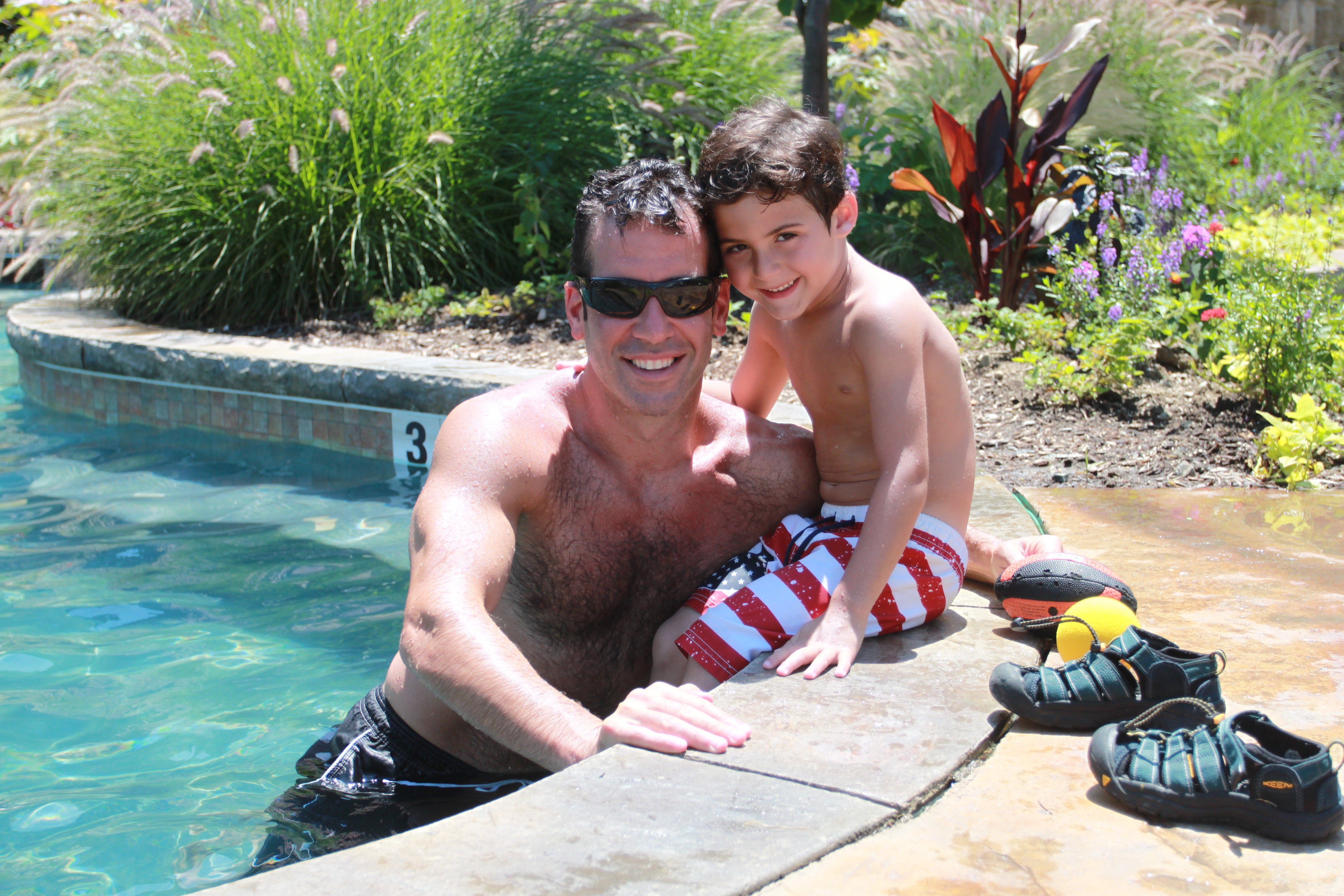 Father and son poolside