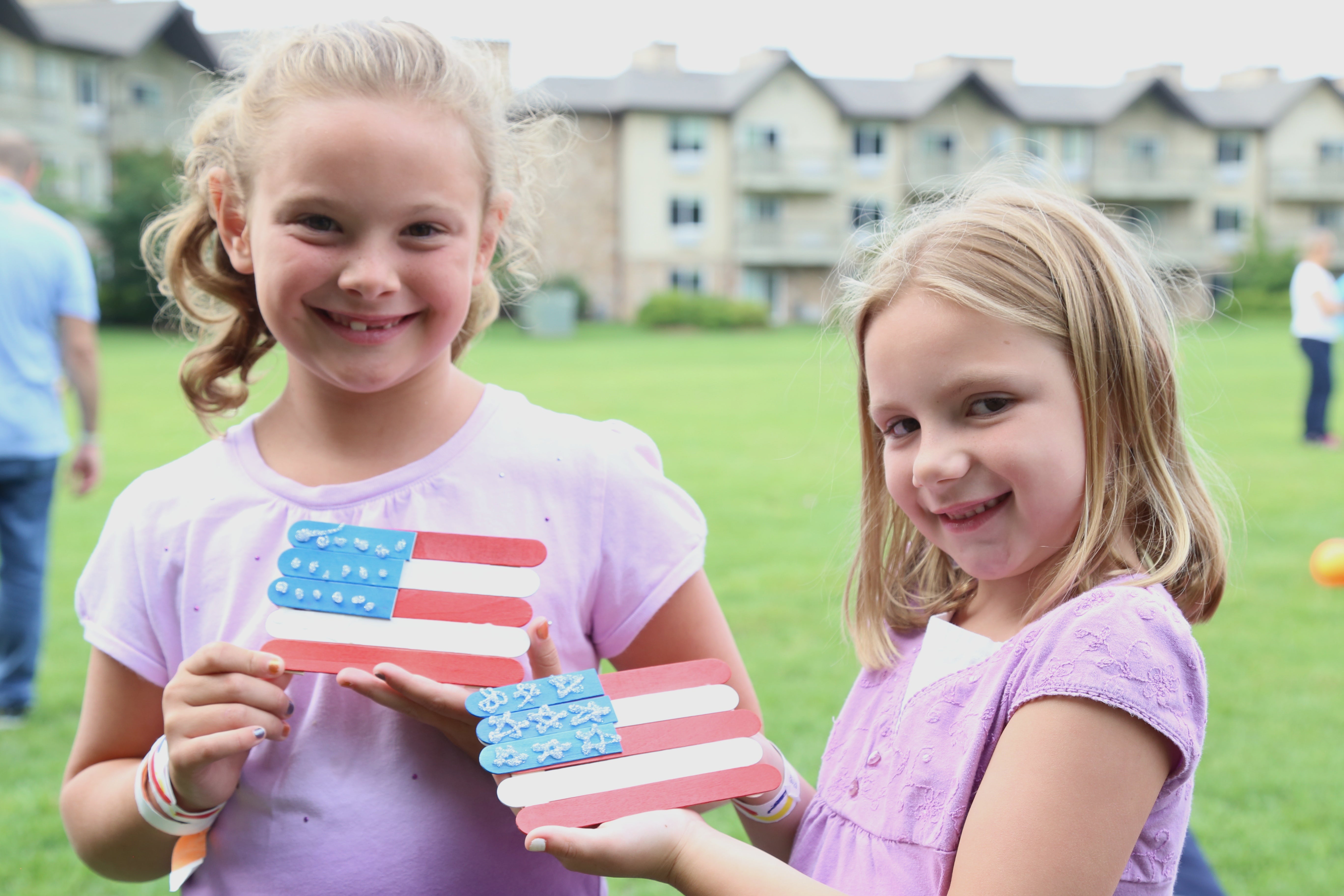Two girls holding a handmade american flag craft